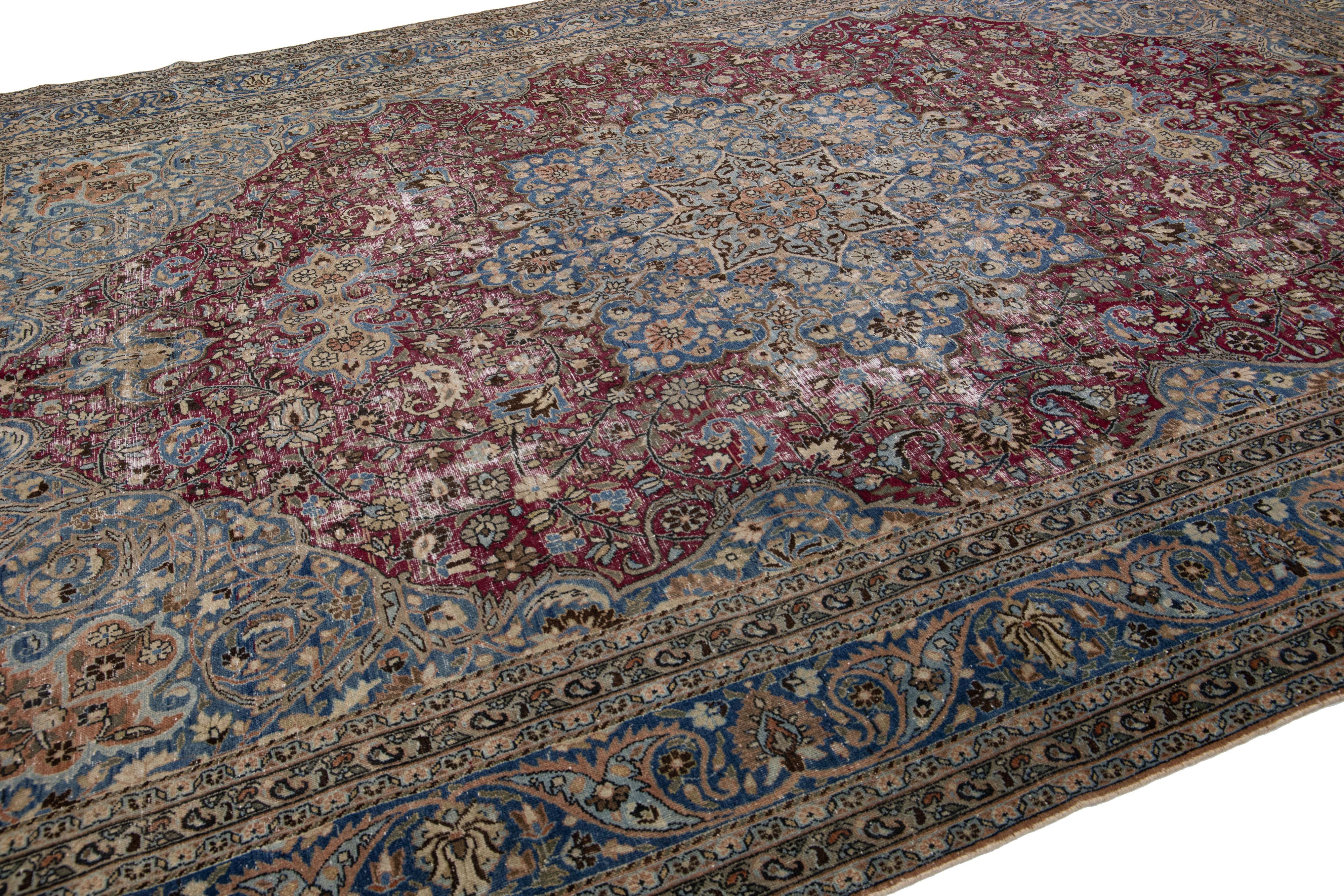 Antique Persian Mashad Red and Blue Handmade Wool Rug with Rosette Motif In Distressed Condition For Sale In Norwalk, CT