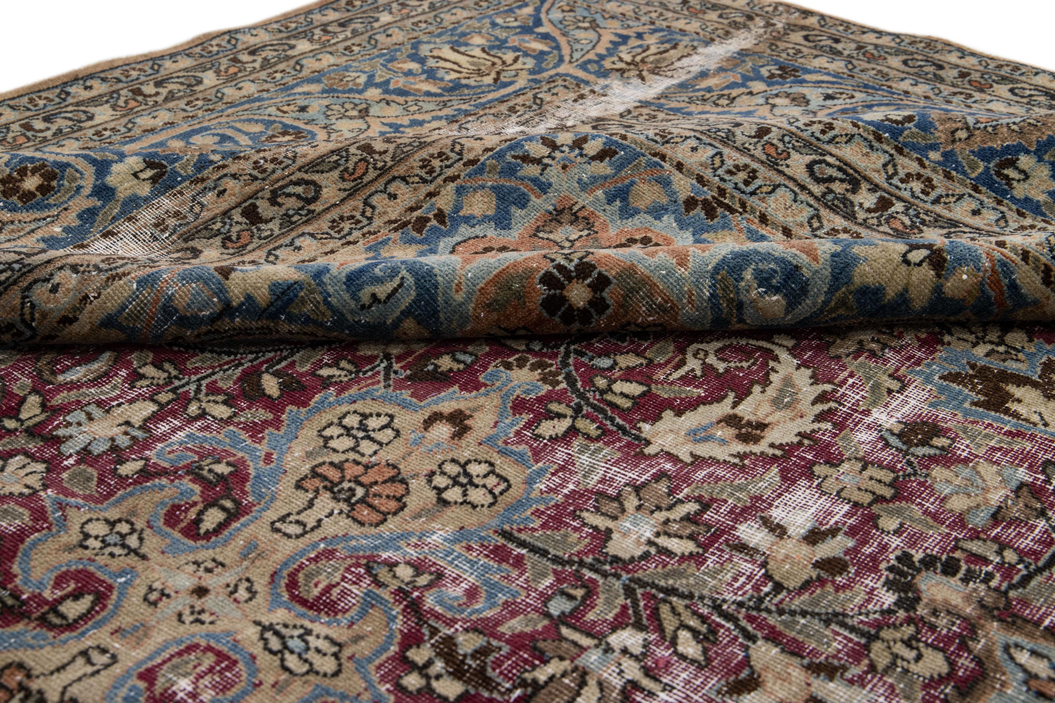 20th Century Antique Persian Mashad Red and Blue Handmade Wool Rug with Rosette Motif For Sale