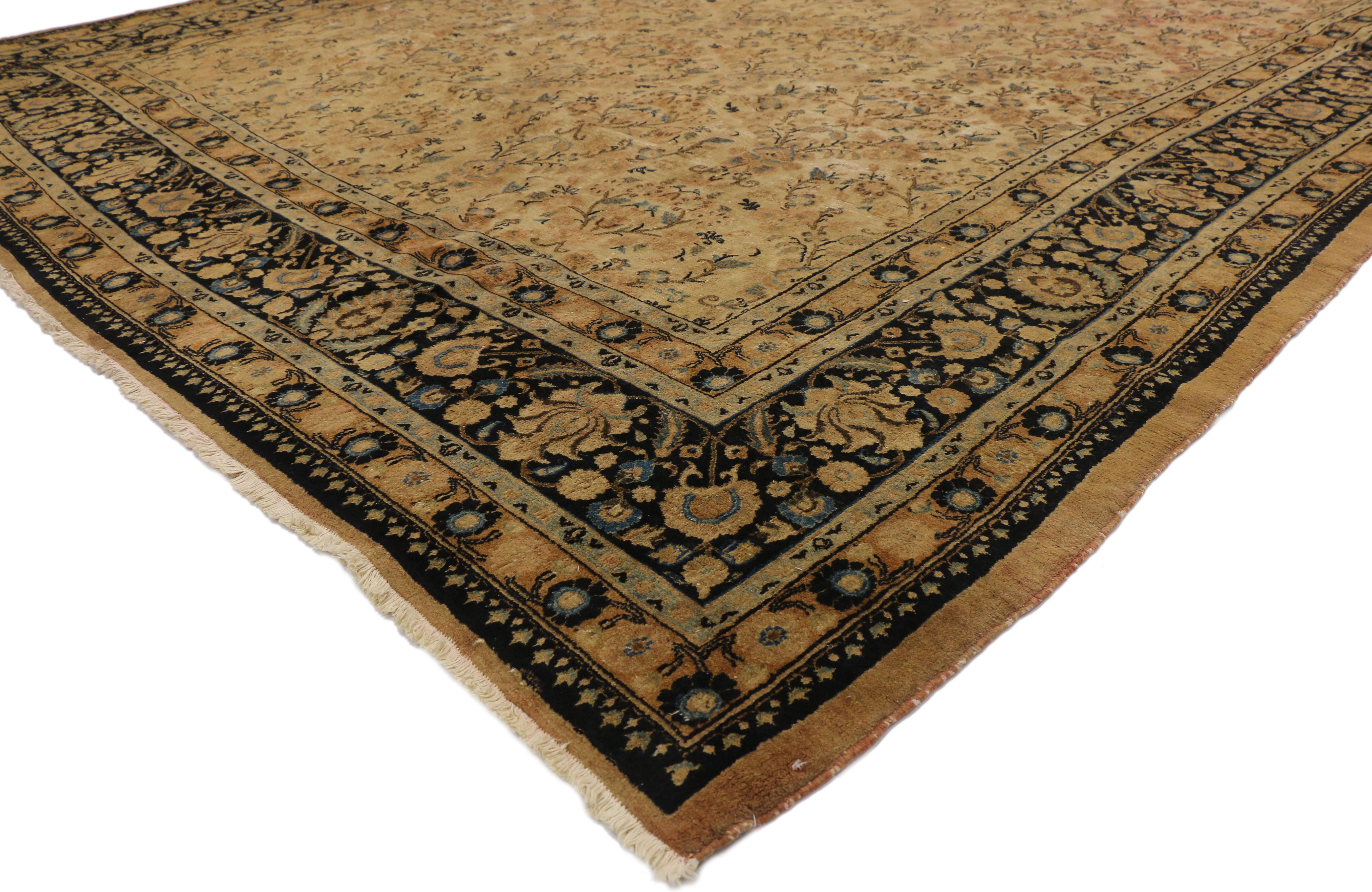 75596 antique Persian Mashhad rug with shabby chic Rustic European Cottage style. This hand knotted wool antique Persian Mashhad rug features a gorgeous all-over pattern of repeating floral sprays on a neutral abrashed field. A darker primary border