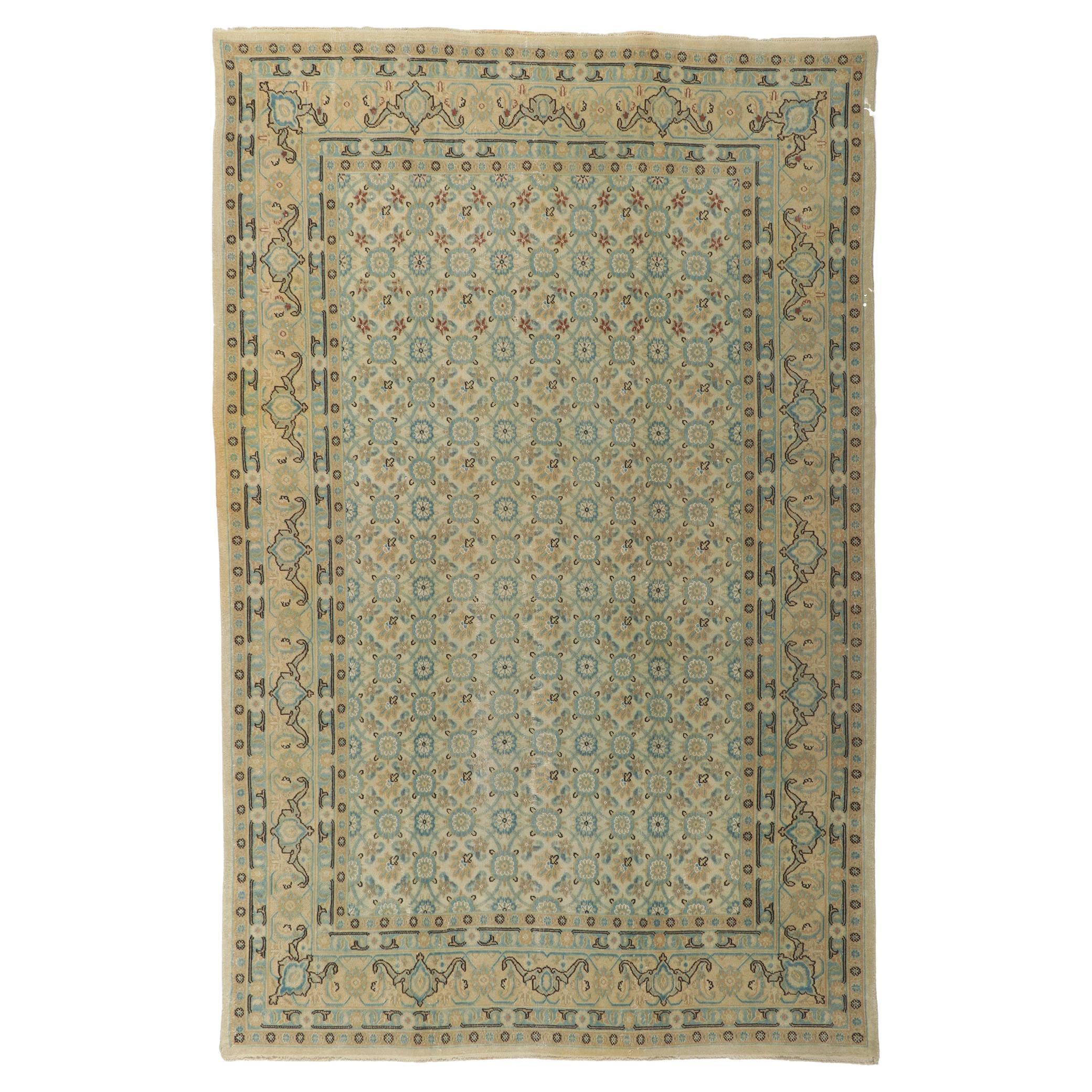 Antique Persian Mashhad Rug with Soft, Light Colors