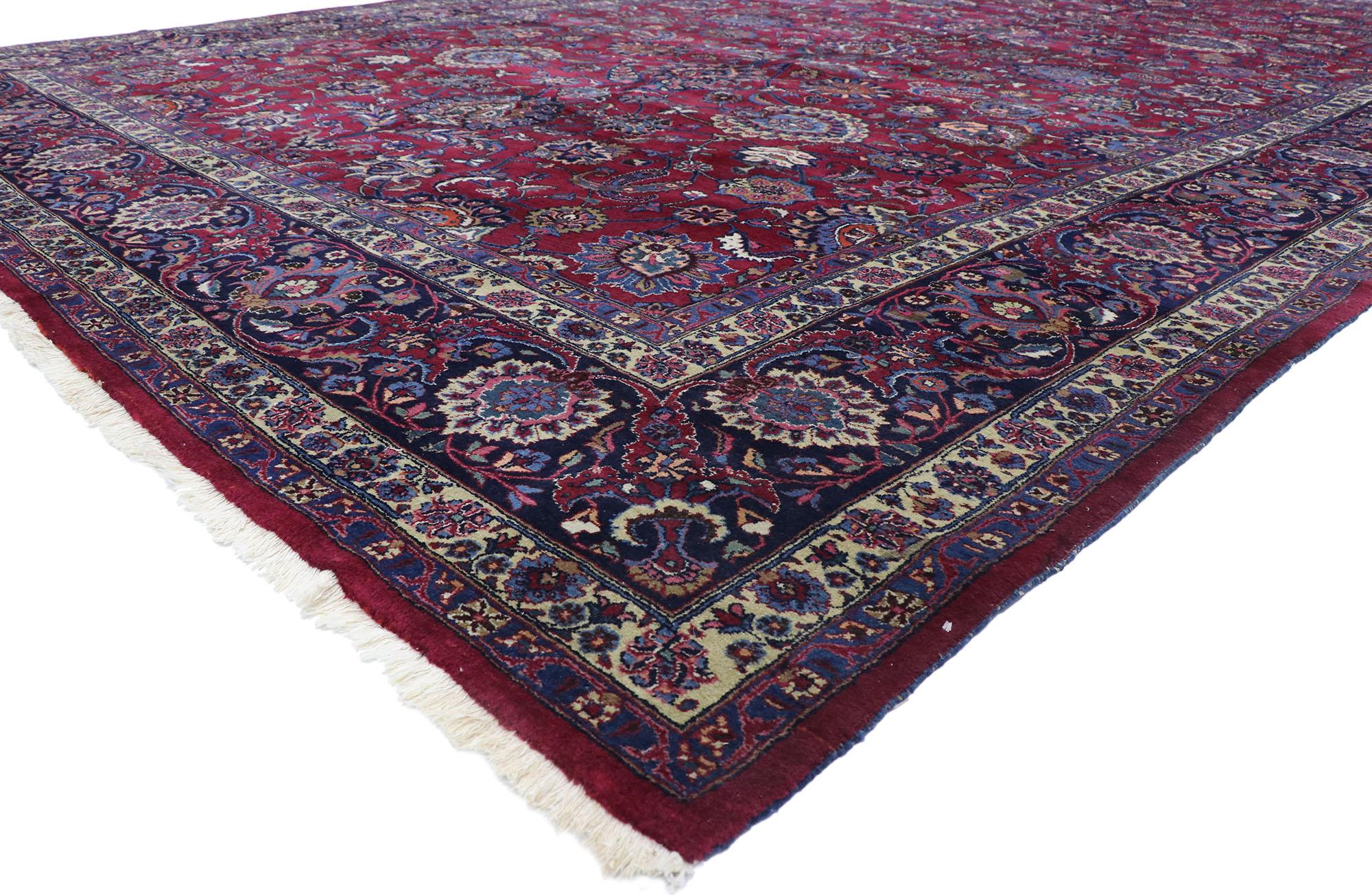 78066 antique Persian Mashhad rug with Victorian Elizabethan style 12'00 x 19'07. With its beguiling beauty and rich jewel-tones, this hand-knotted wool antique Persian Mashhad rug is poised to impress. The abrashed burgundy field is covered with a