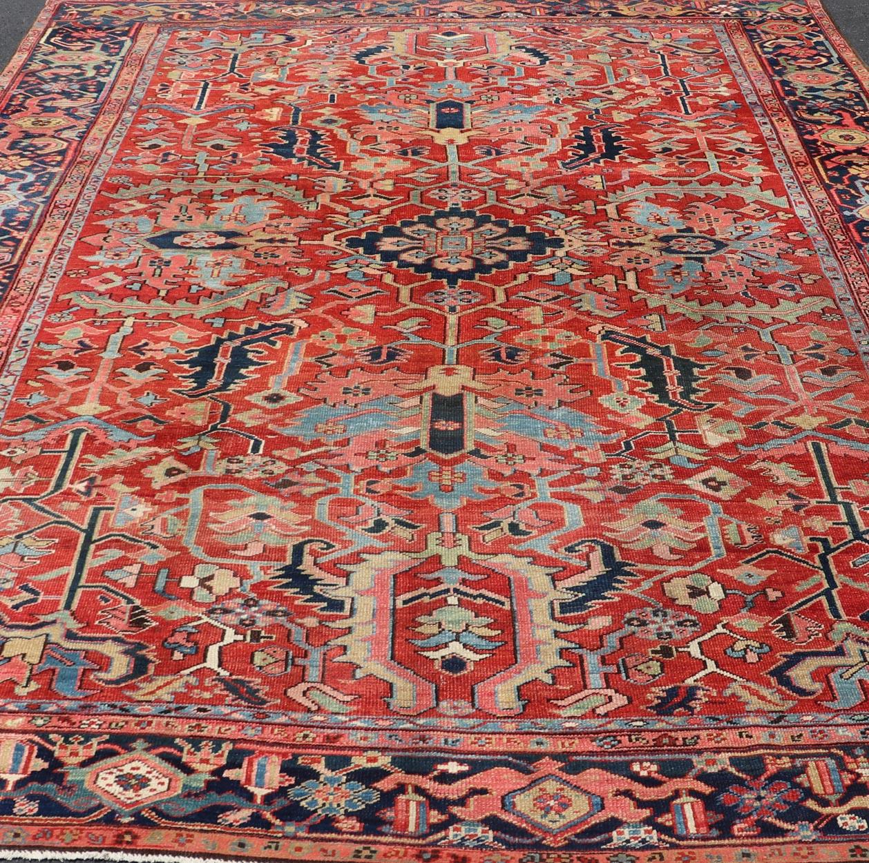 Antique Persian All Over Large Serapi Rug With Rust Red Background and Blue Border and large scale geometric Flowers. Keivan Woven Arts / Rug / C-0301, country of origin / type: Iran /Serapi, circa 1900. 

Measures: 10' x 13'10.   

This Antique