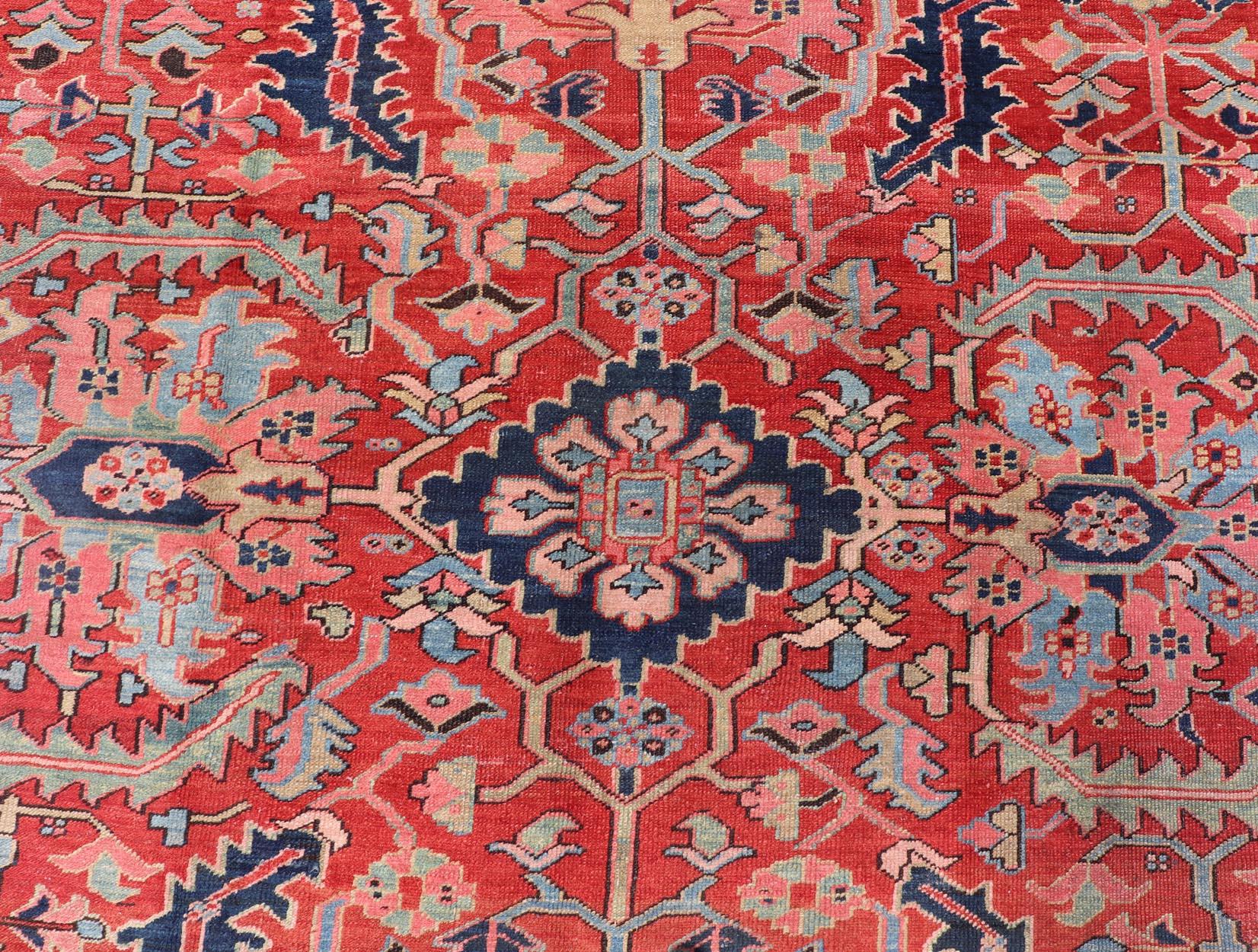 Hand-Knotted Antique Persian Medallion Serapi Rug With Red Background and Blue Border For Sale