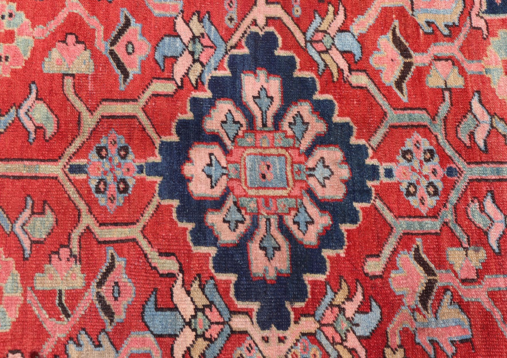 Early 20th Century Antique Persian Medallion Serapi Rug With Red Background and Blue Border For Sale