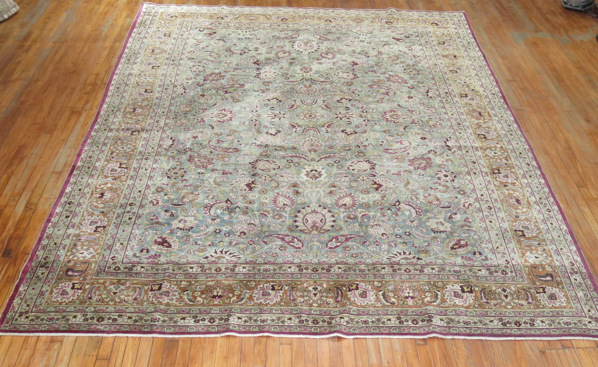 An early 20th century room size antique Persian Meshed rug.

9'9'' x 12'9''