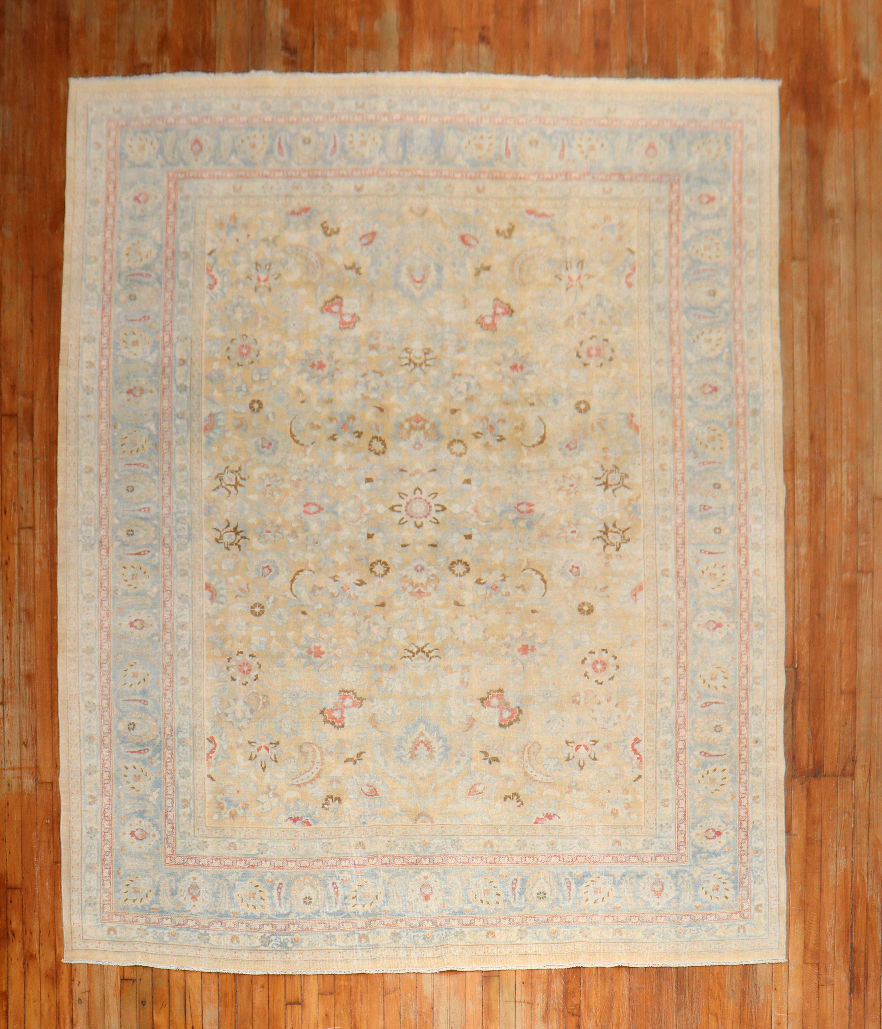 A room-size Persian Meshed rug with an all-over formal design on a wheat field, an icy blue border, accent colors in red and brown, circa 1940.

Measures: 8'4'' x 11'3''

The city of Meshed is one of Iran's oldest cities, located in the