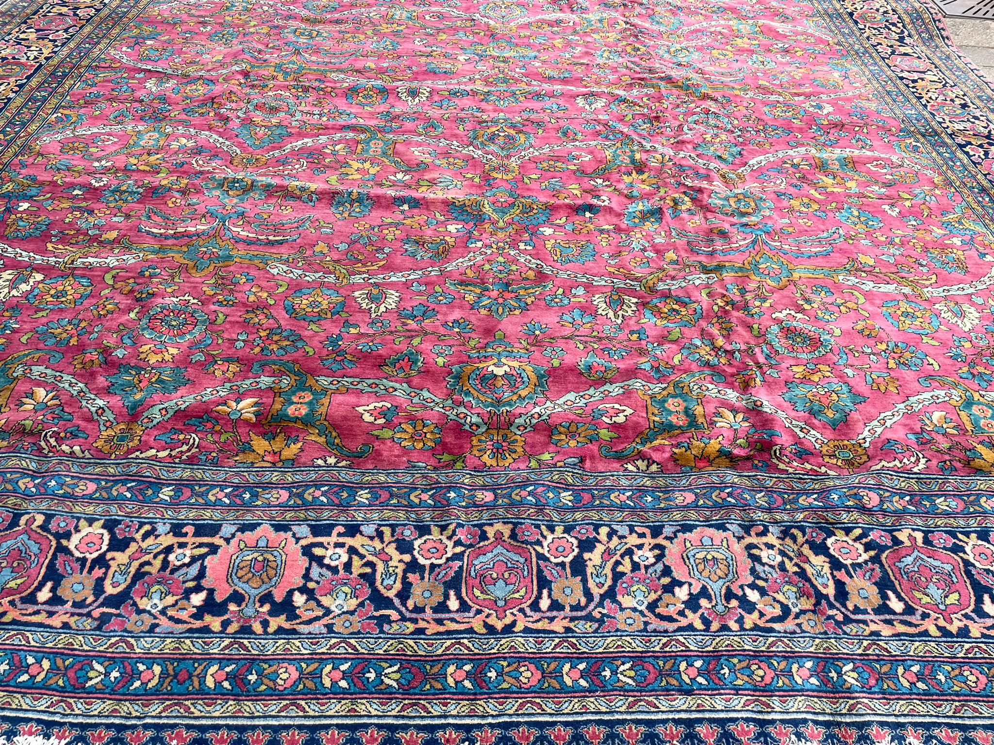 Indulge in the timeless elegance of our Antique Handmade Northwest Persian Sarouk Mohajeran Rug the most unusual, a precious gem dating back to around 1910. This exquisite piece, measuring 13'3
