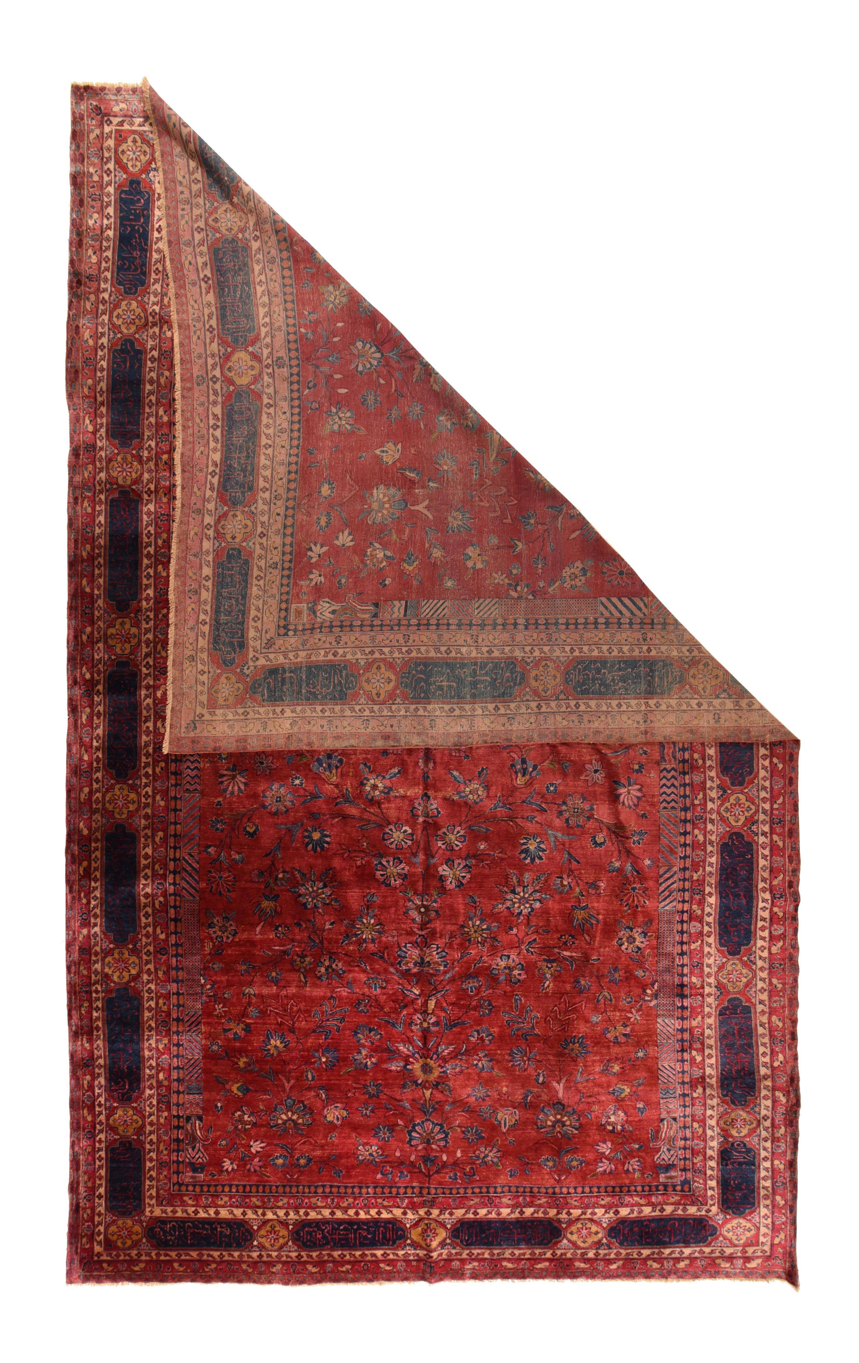 This quite finely woven Central Persian city carpet has a velvety pile of Manchester-spun Merino wool. The royal blue inscription cartouche and quatrefoil border frames the ruby red field with a small inscription octogramme developing stem, vines