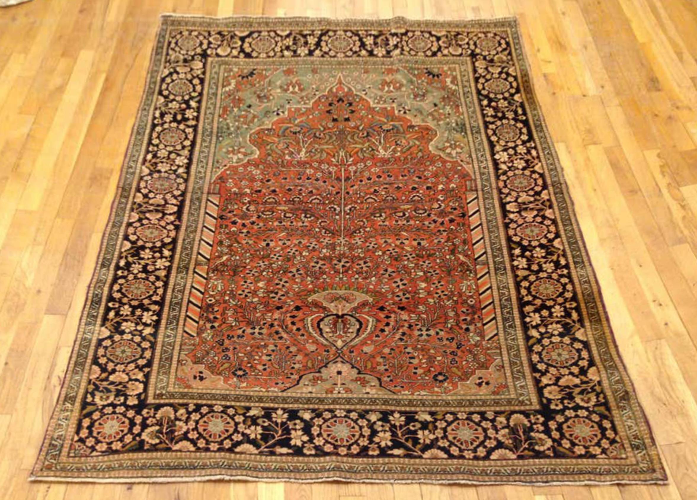 An antique Persian Mohtesham Kashan rug, circa 1890, size 6'7 x 4'6. This fine hand-knotted rug features a tight weave, with a soft, silky finish to the wool pile. The Directional central field is characterized by a lantern at one end, pillars on