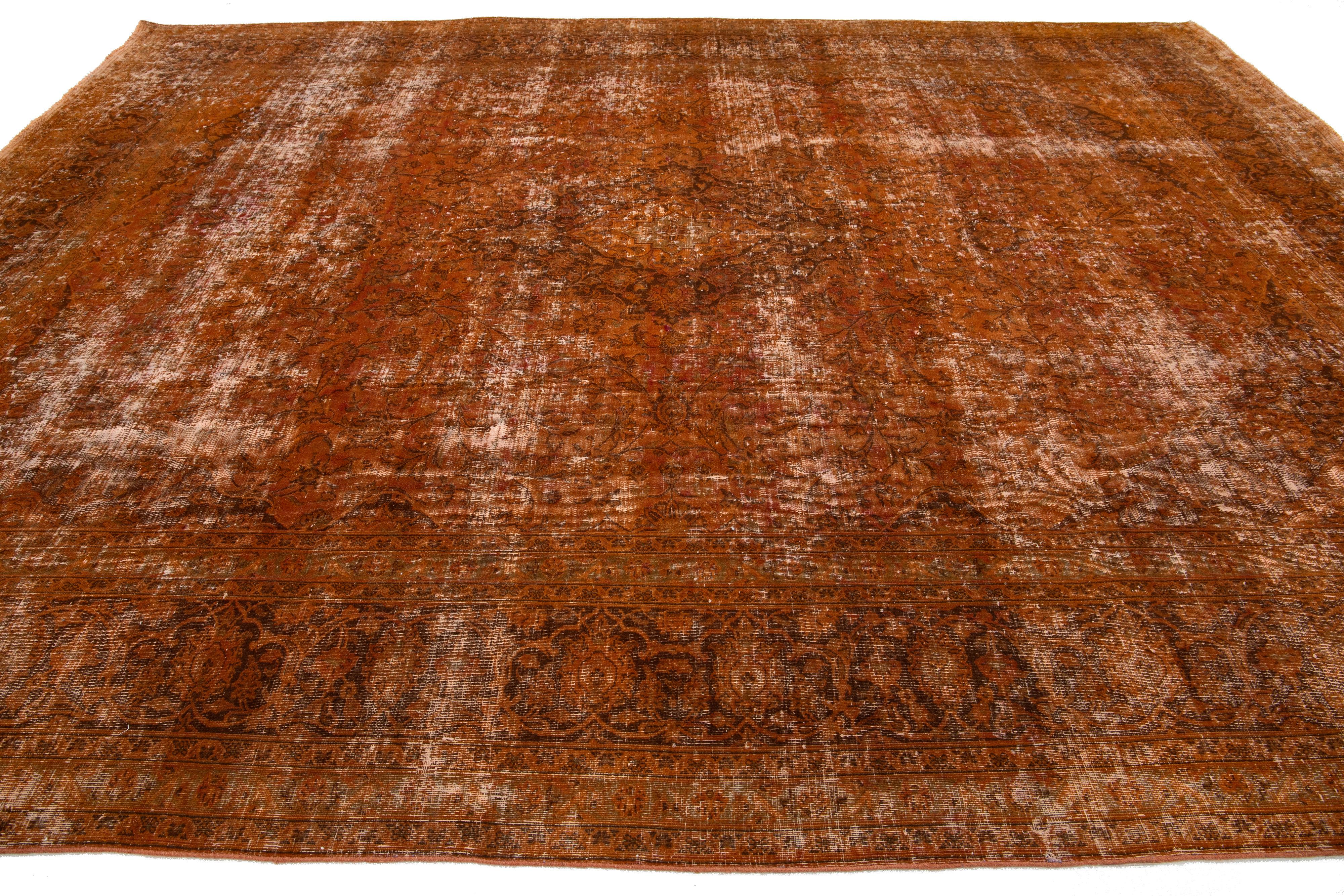20th Century Antique Persian Overdyed Wool Rug In Orange With Floral Design For Sale