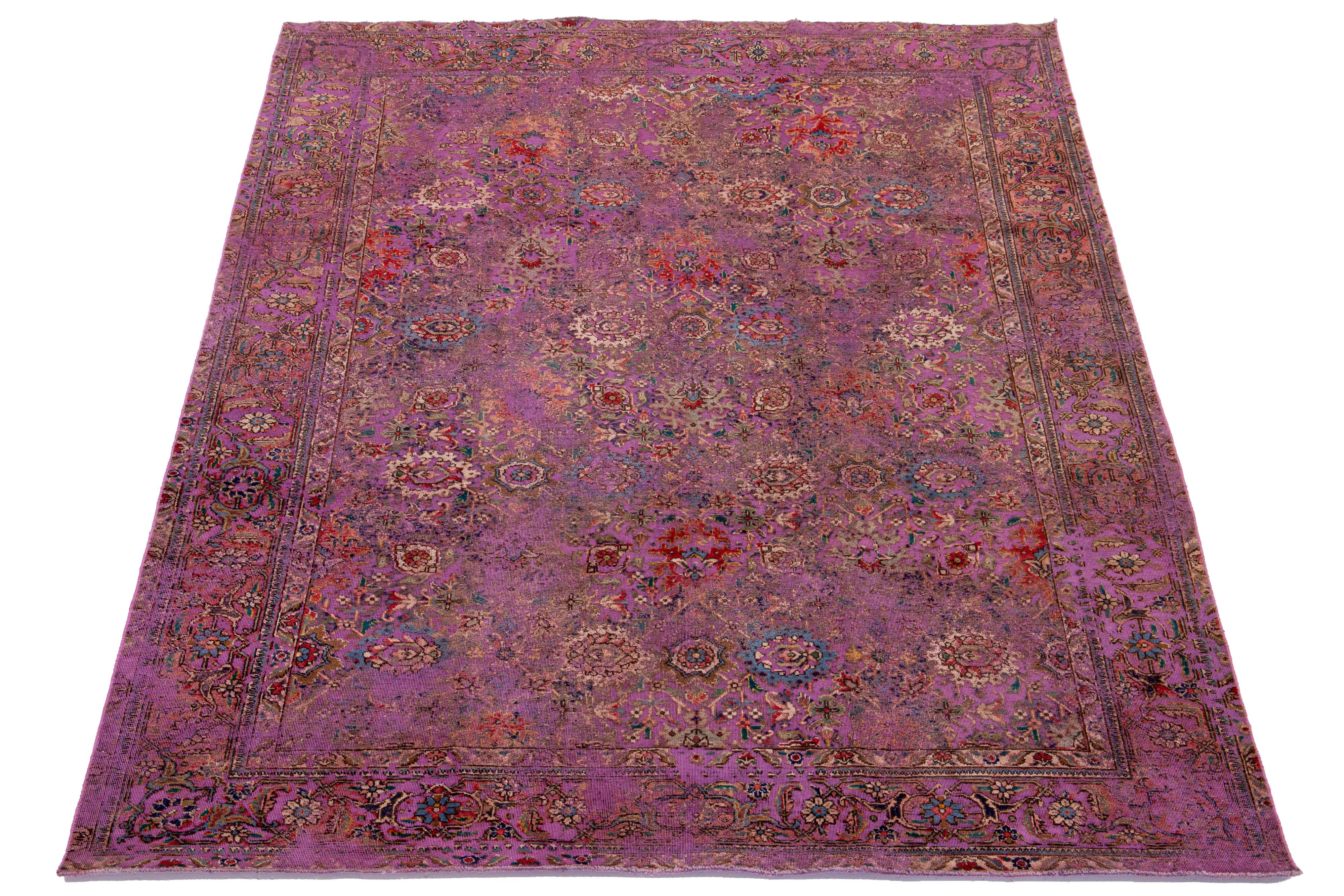 This antique purple Persian wool rug showcases a beautiful floral design with vibrant multicolor accents.

This rug measures 7'4'' x 10'5