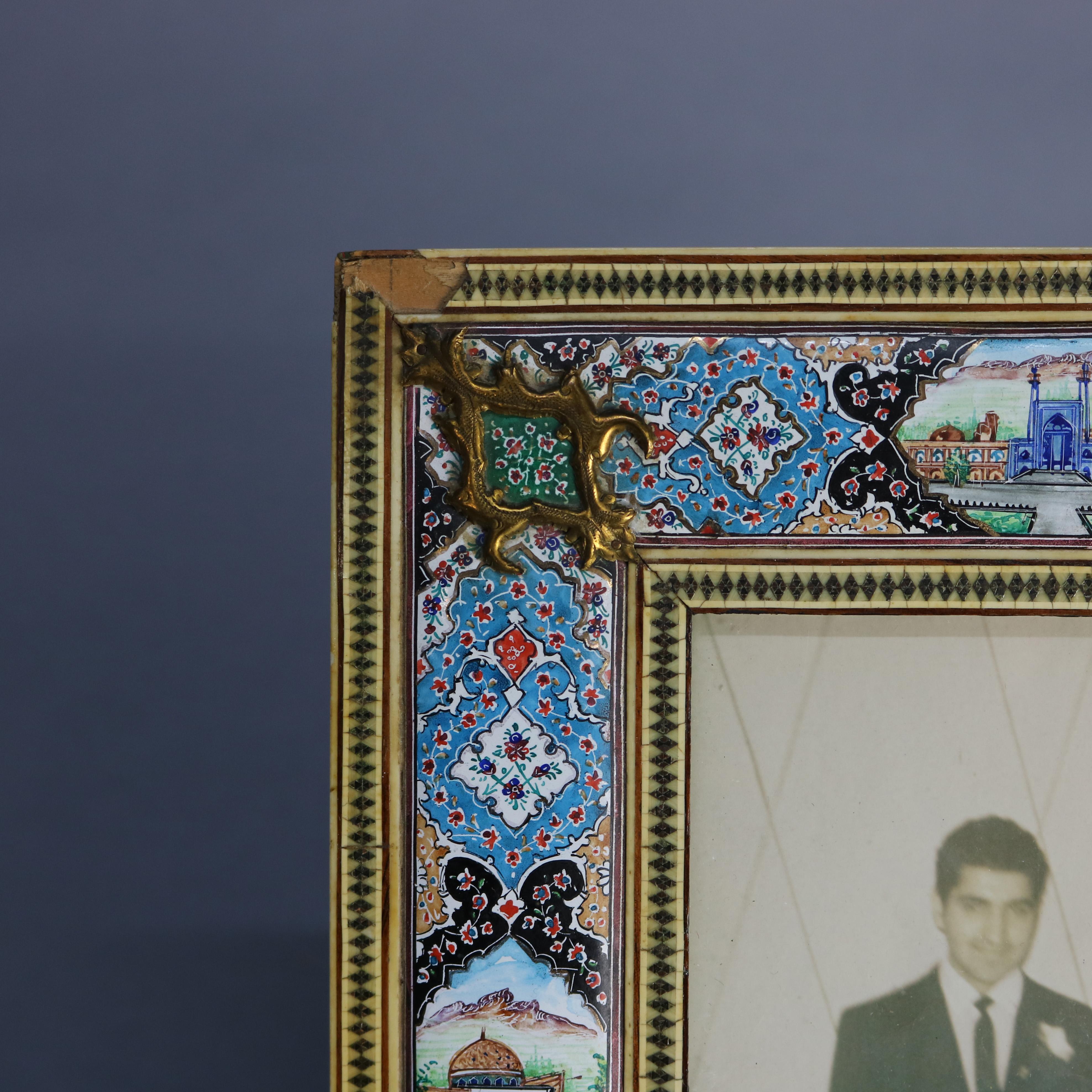 An antique Persian pictorial picture frame offers giltwood casing with enamel on copper mosaic design with hand painted cityscape reserves, 19th century

Measures: 11.25