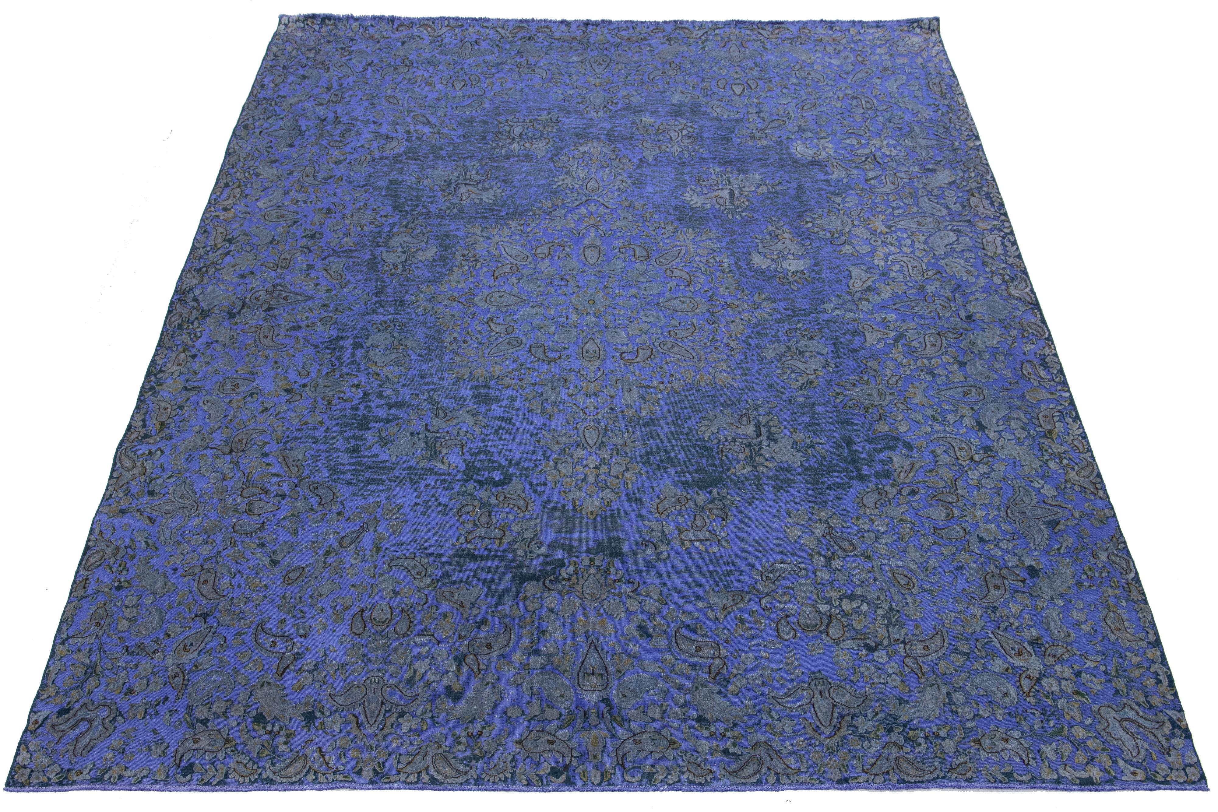 This antique Iris Purple Overdyed Persian wool rug features a rosette design with beige and gray accents.

This rug measures 9'8'' x 13'10