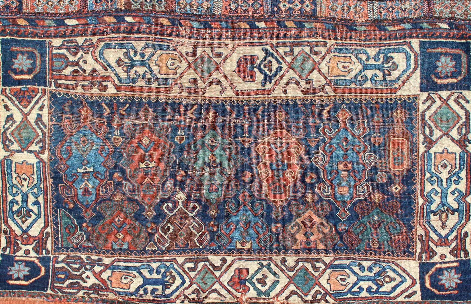 Antique Persian Qashqai rug with medallion design in blue, orange, mint green, and cream, rug 18-1006, country of origin / type: Iran / Qashqai, circa 1880

The Qashgai nomads are found in the Fars province in southwest Iran. They move twice a