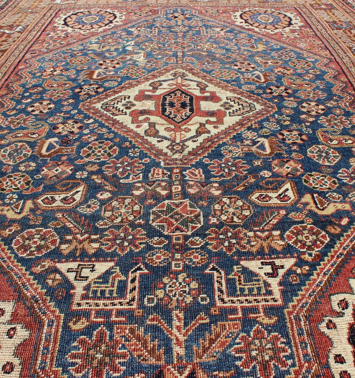 Wool Antique Persian Qashqai Rug with Central Medallion in Ink Blue and Faded Red For Sale