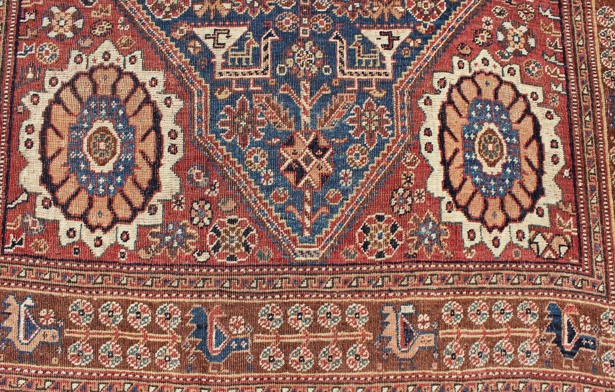 Tribal Antique Persian Qashqai Rug with Central Medallion in Ink Blue and Faded Red For Sale