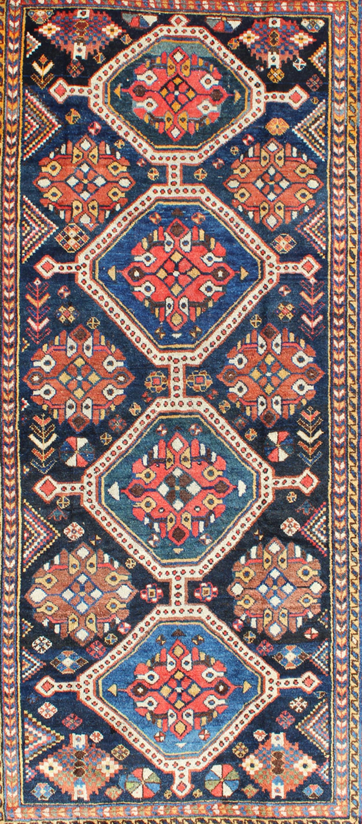 Tribal Antique Persian Qashqai Rug with Four-Medallion Design in Blue, Red, Brown Tones For Sale