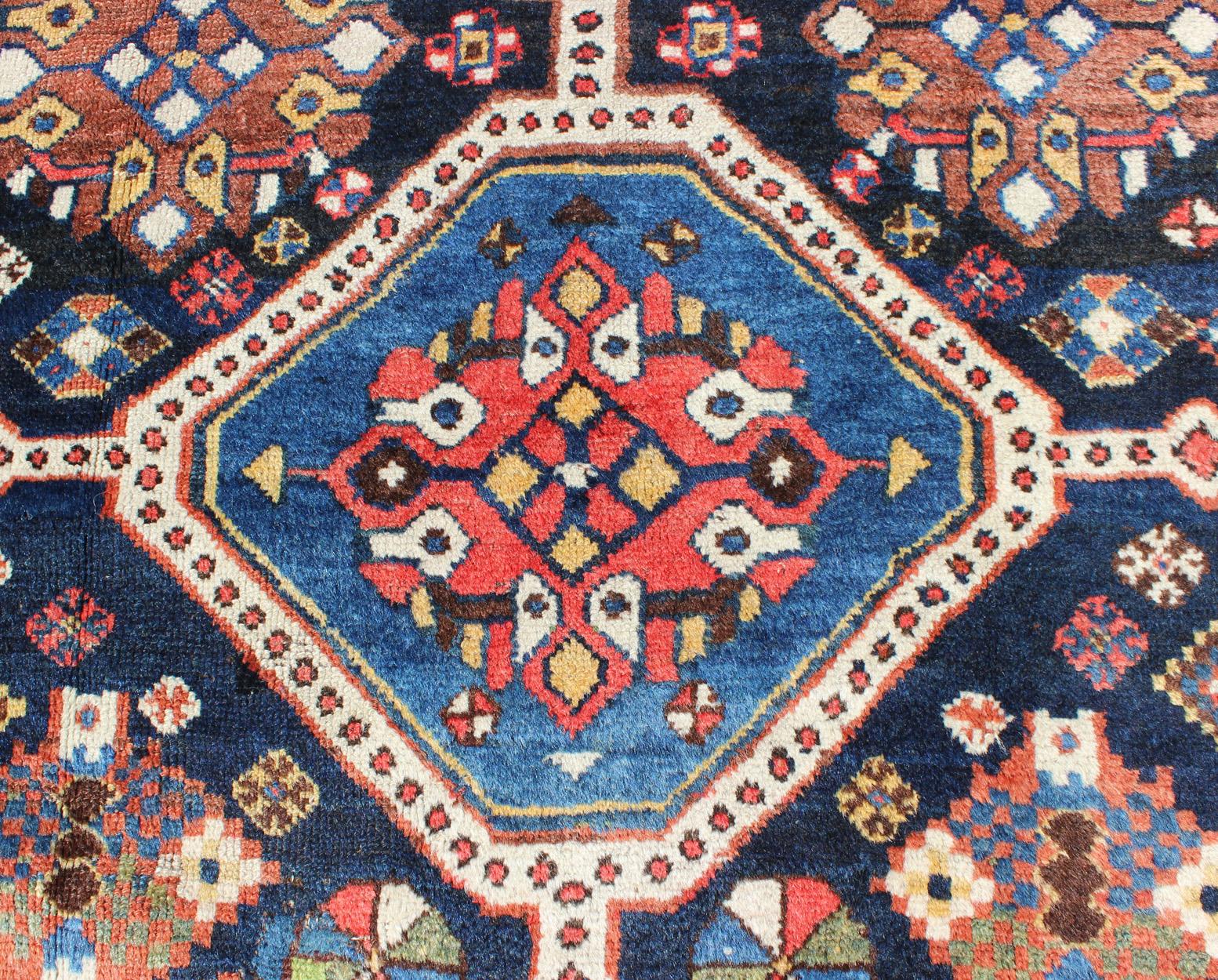 Wool Antique Persian Qashqai Rug with Four-Medallion Design in Blue, Red, Brown Tones For Sale