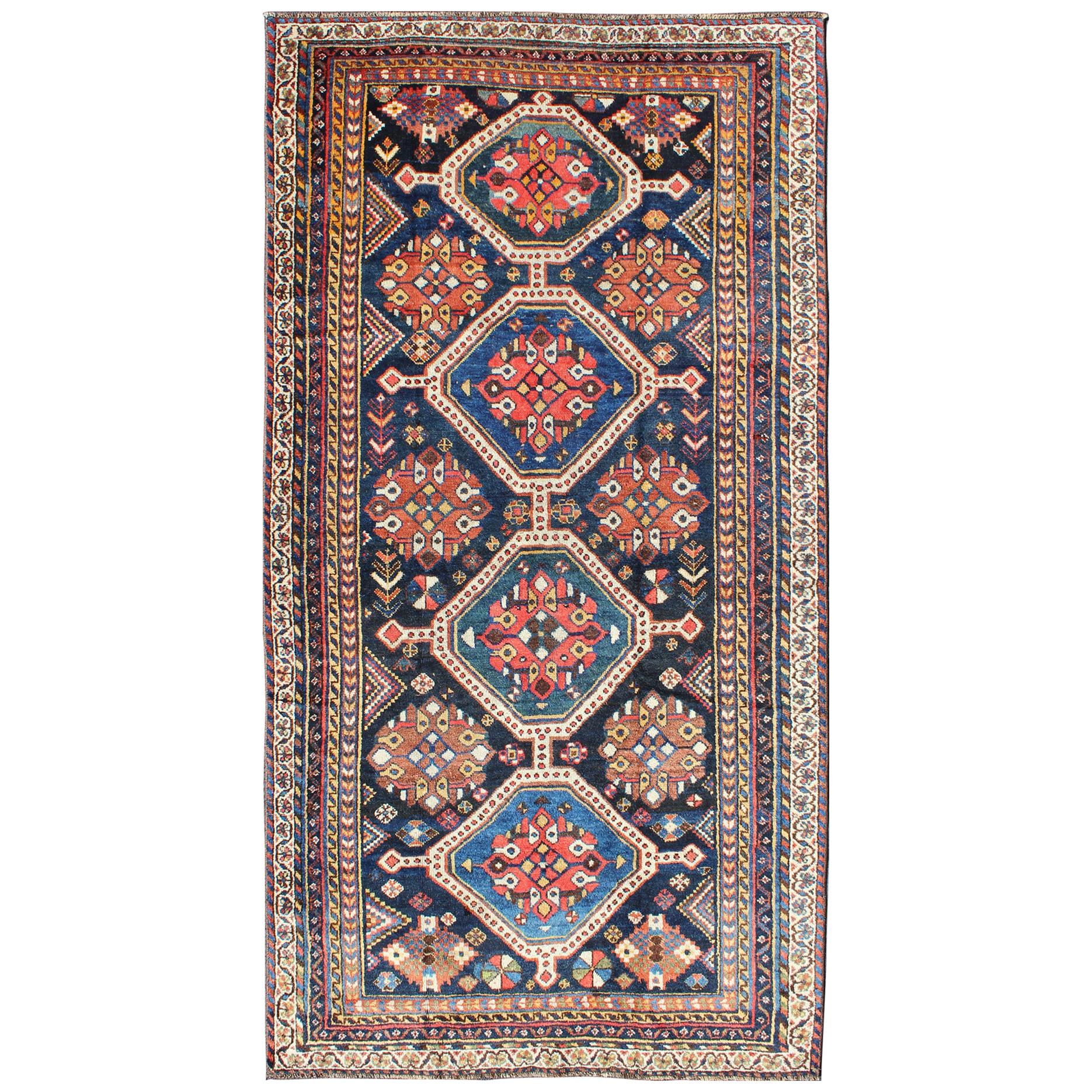 Antique Persian Qashqai Rug with Four-Medallion Design in Blue, Red, Brown Tones For Sale