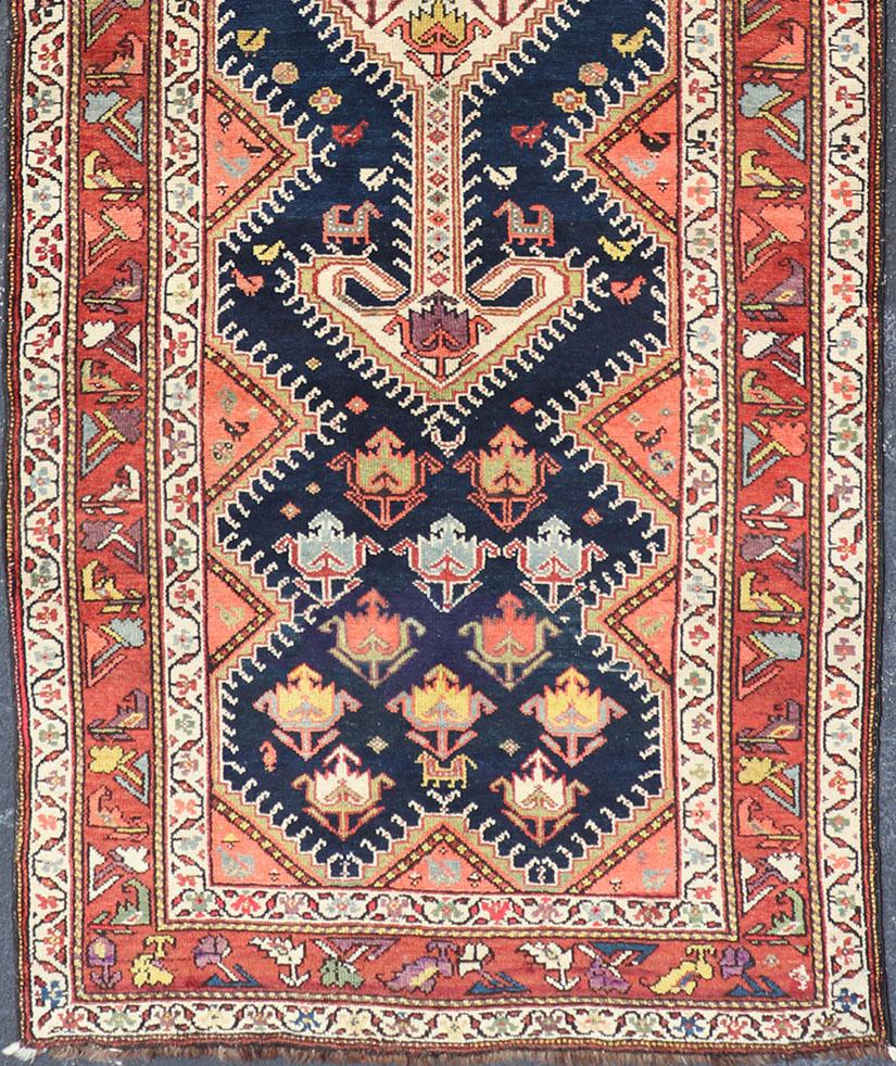 Qashqai antique runner in multi-colors with multi-medallion geometric design, rug TU-MEV-PM809, Keivan Woven Arts / country of origin / type: Iran / Qashqai , circa 1890.

This antique Persian Qashqai rug features a unique blend of colors and an