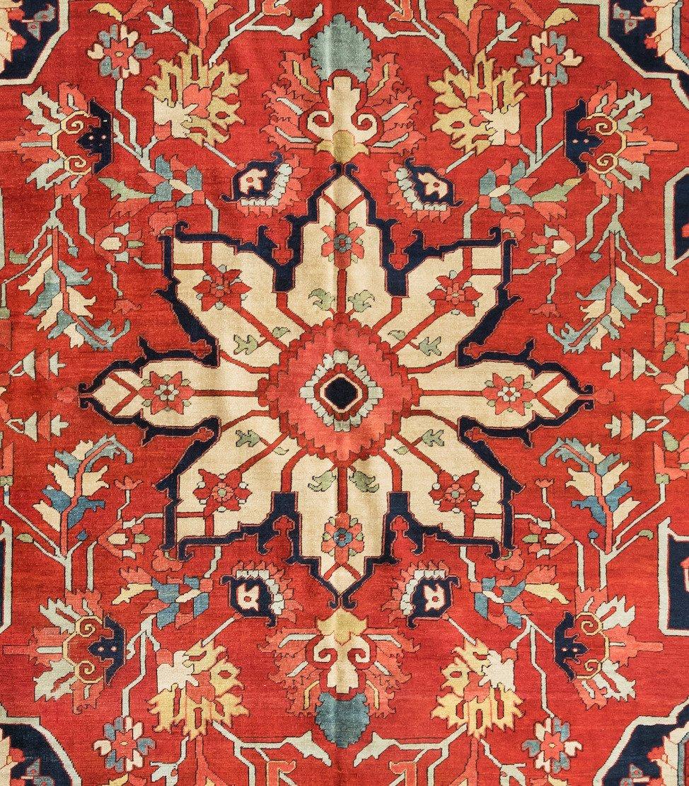 This is a pristine antique Persian red and navy Serapi carpet with a medallion from the 1900s-1910s. This lovely carpet measures 9.1 x 12.2 ft.