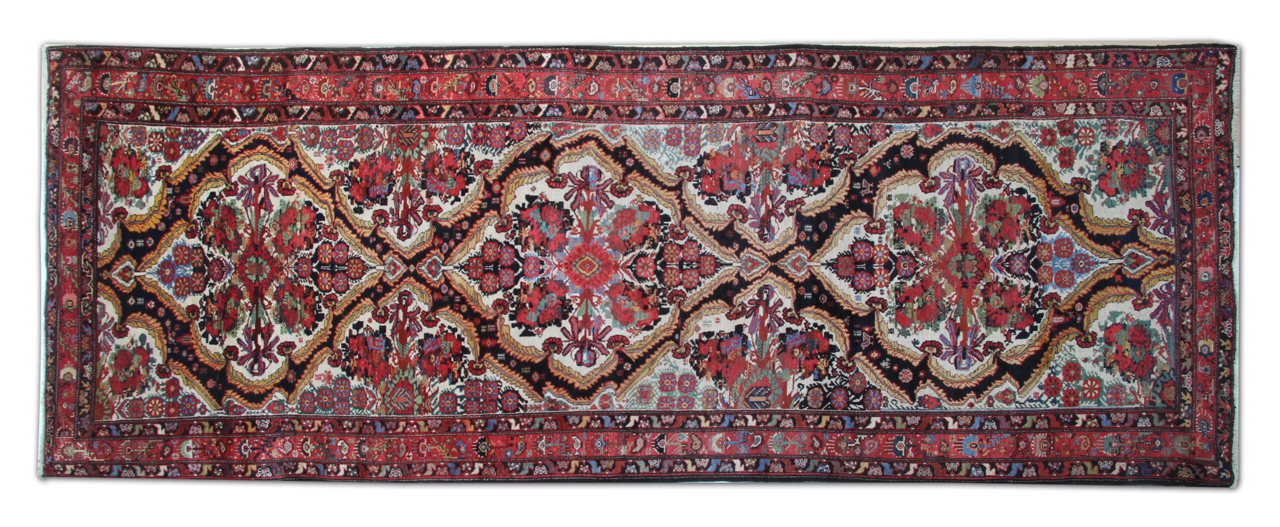 This is a beautiful example of the 19th-century antique rug hand-knotted in Iran. Featuring a floral botanical central design hand-knotted with handspun wool and cotton. The vibrant colours have been dyed using vegetable dyes, and rich reds and