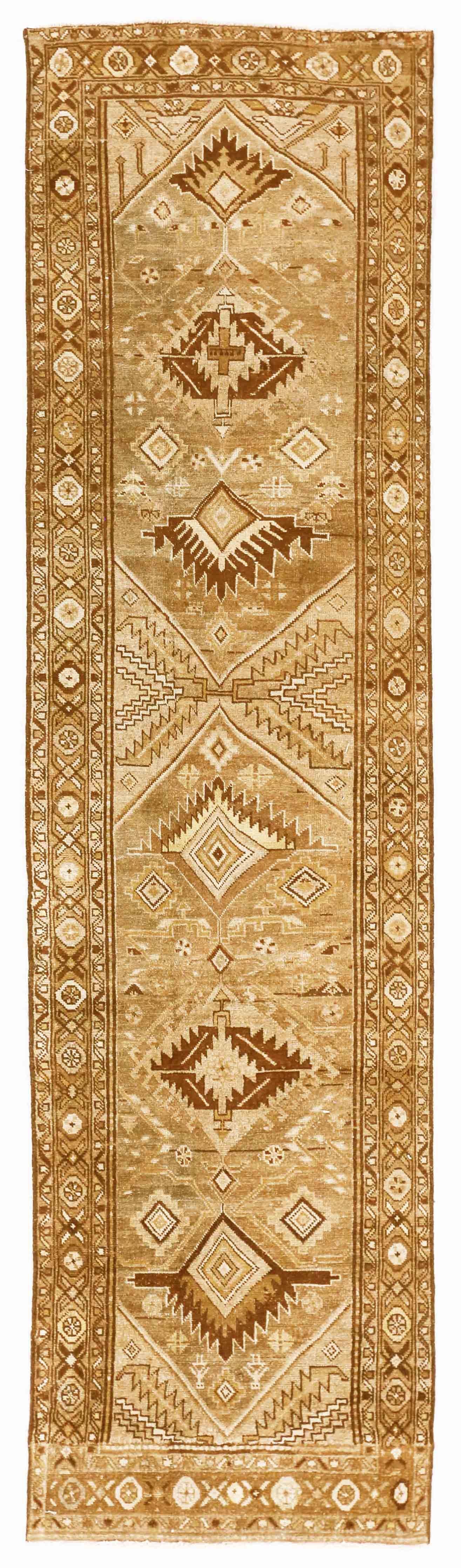 Antique Persian rug made from handspun, organic wool with fascinating geometric patterns popular in Azerbaijan rugs from the Caucasus region. It has a terrific blend of brown, beige, gray, and touches of green that will instantly draw attention to