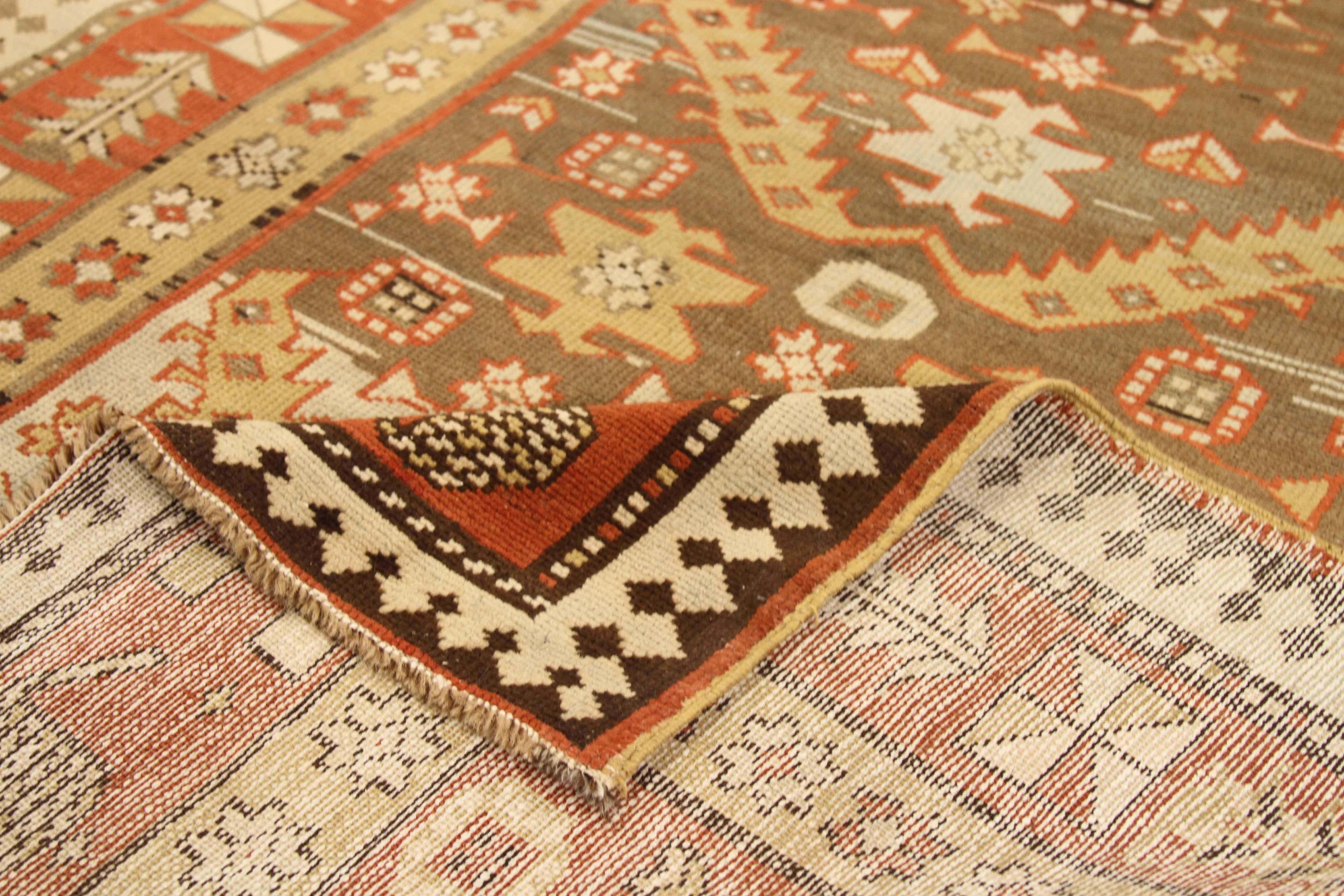 Antique Persian rug handmade in the 1920s from the highest quality of wool and vegetable dyes. It features an ancient tribal design with highly intricate details crafted using Ghafghaz style of weaving. Traditional colors of ivory, red, yellow, and