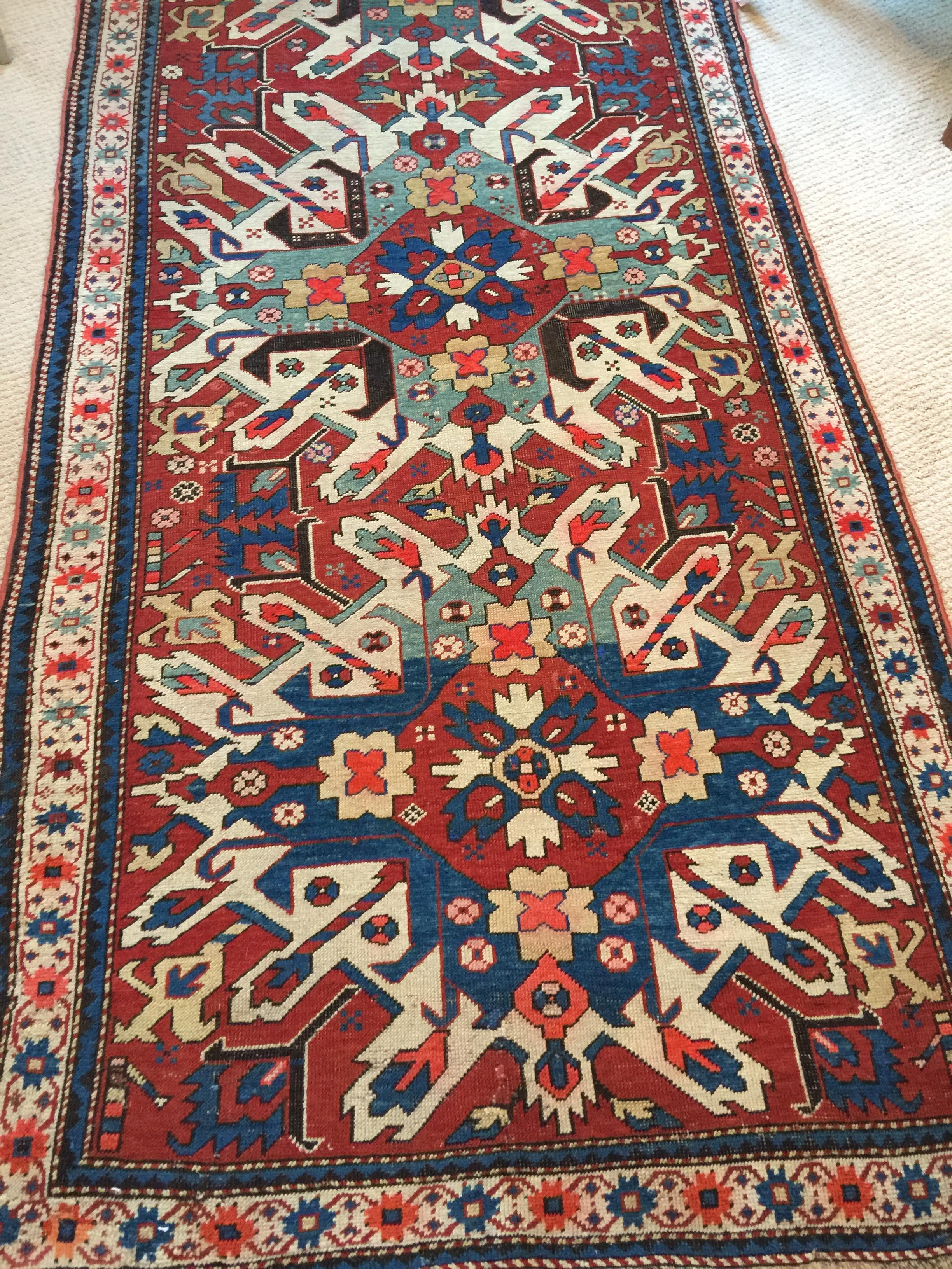 Immerse yourself in the enchanting world of antique rugs with this extraordinary late 19th-century Eagle Kazak Chelaberd wool rug carpet. Crafted with meticulous attention to detail, this rug is not merely a floor covering but a true masterpiece