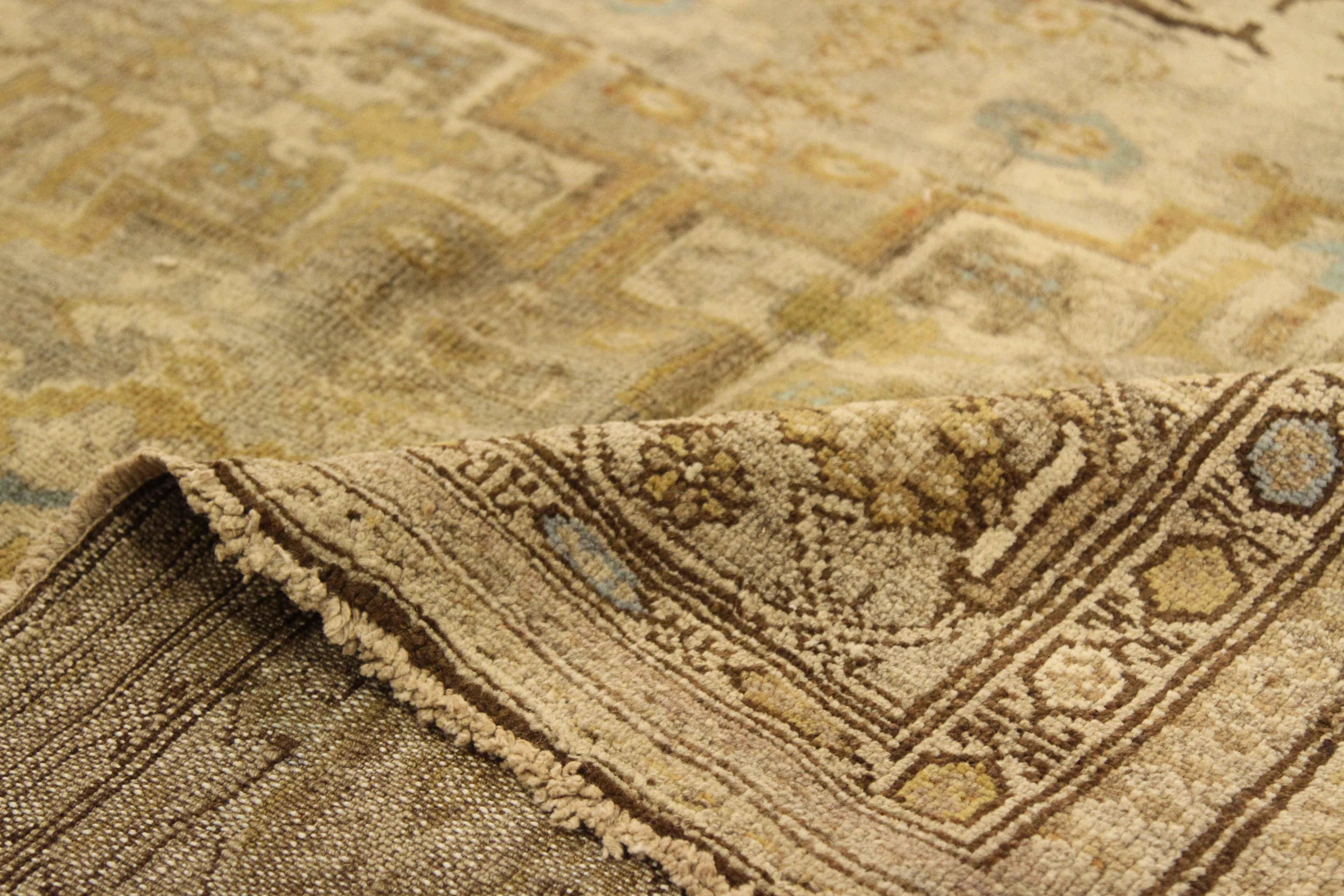 Handwoven in the 1940s, this antique Persian rug is made of fine wool and dyed with rustic colors such as brown, beige, ivory, and some touches of blue. Ancient Malayer weavers were inspired by nature and this piece has a fading pattern depicting