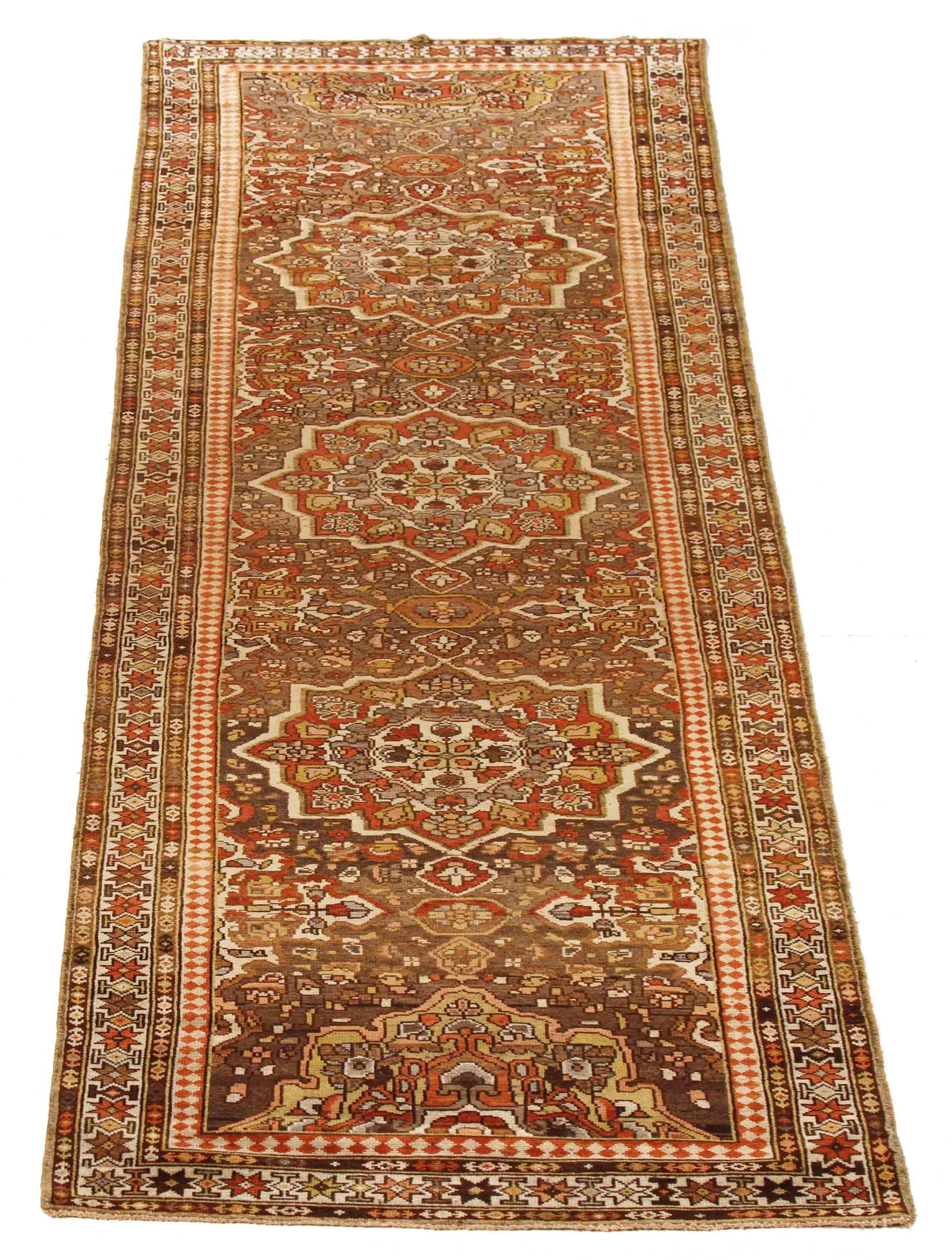 Handmade from high-grade wool and vibrant organic dyes, this antique Persian rug has a captivating set of finely woven geometric patterns on its field bordered by equally splendid elements that Malayer weavers are well-known for. If placed in a