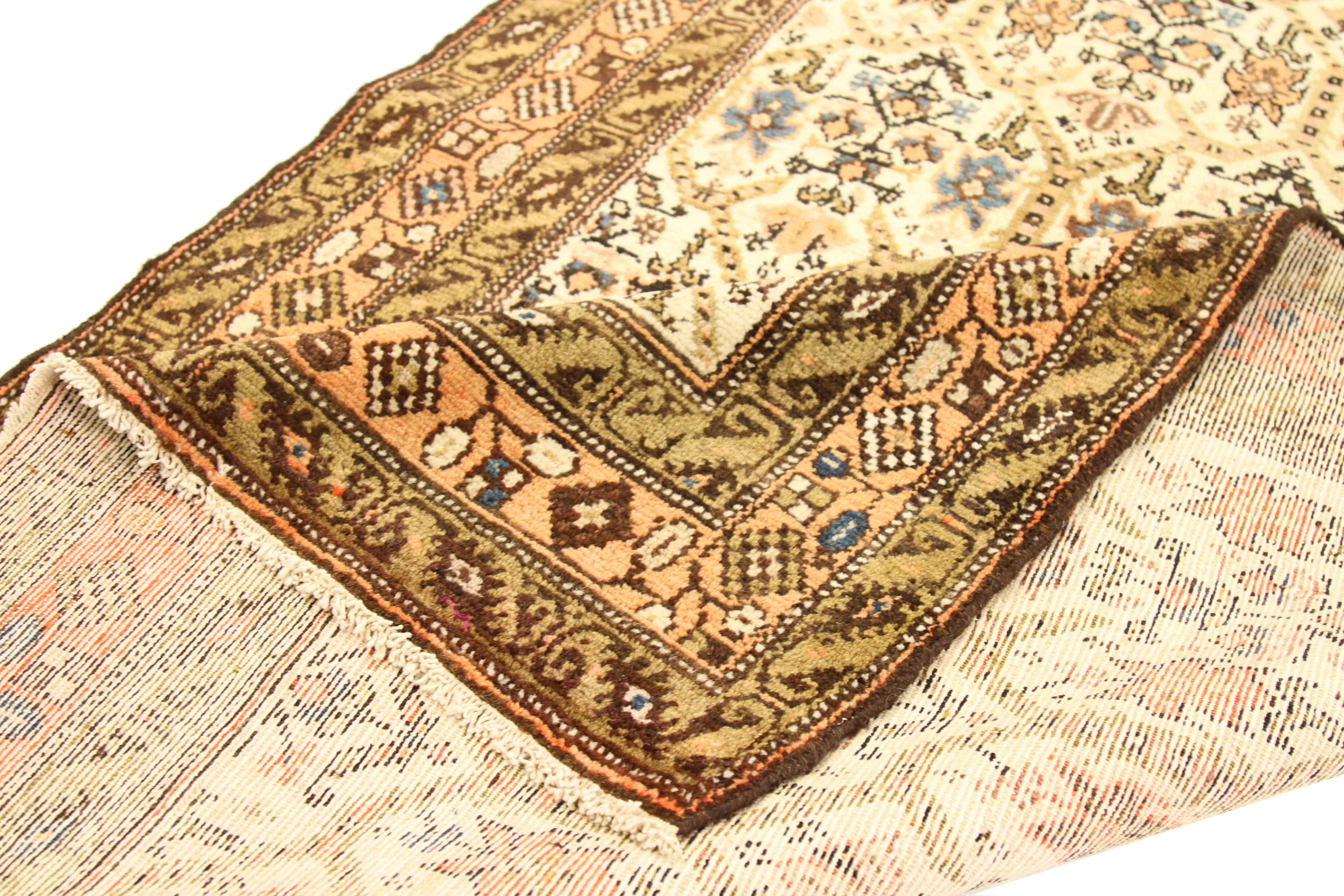 Handmade from the finest wool and organic dyes, this antique Persian rug features an exceptional floral pattern using a unique color blend of blue, green, ivory and yellow. It’s a fine example of the artistry of Malayer weavers and is an excellent