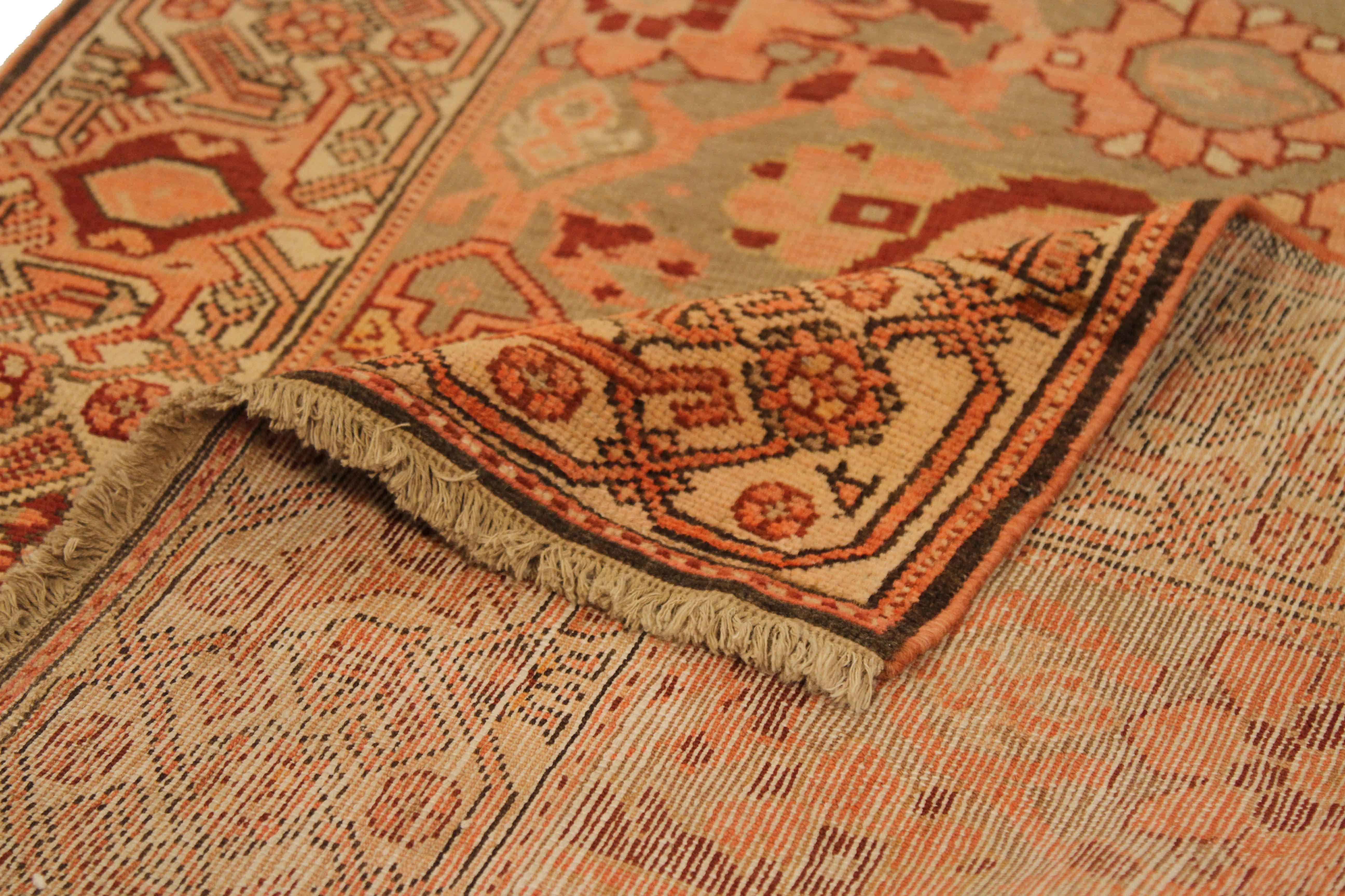 Handmade using the highest quality of wool, this antique Persian rug was made in Malayer fashion featuring a fiery display of floral patterns in red, orange, yellow, and beige. This piece can add contrast to a space in contemporary, Minimalist, and