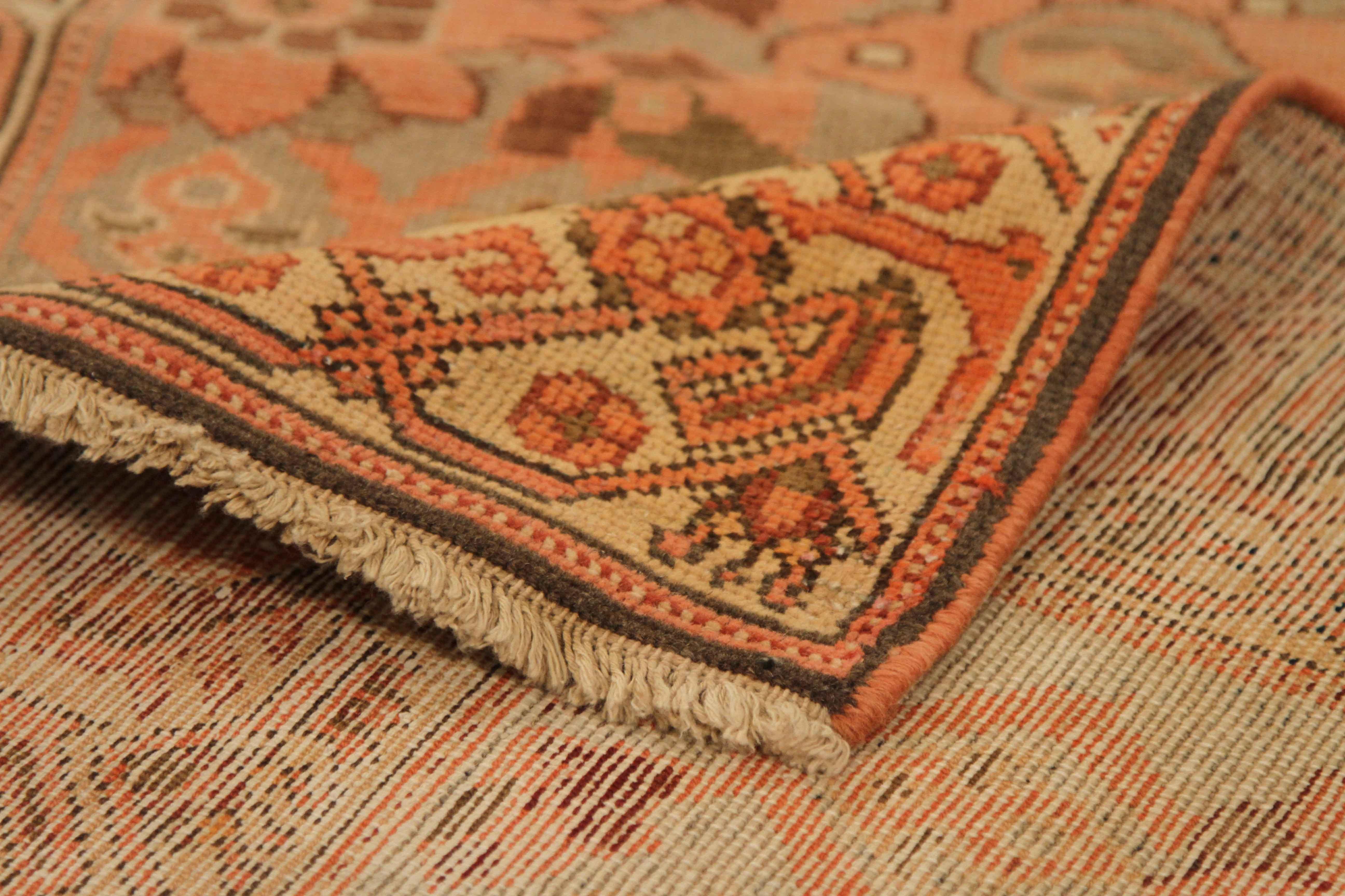 Crafted by hand using the finest wool, this antique Persian rug was designed based on patterns mastered by Malayer weavers thousands of years ago. It has a well-blended color mix of beige, ivory, green, and red which lend the appearance of a flower