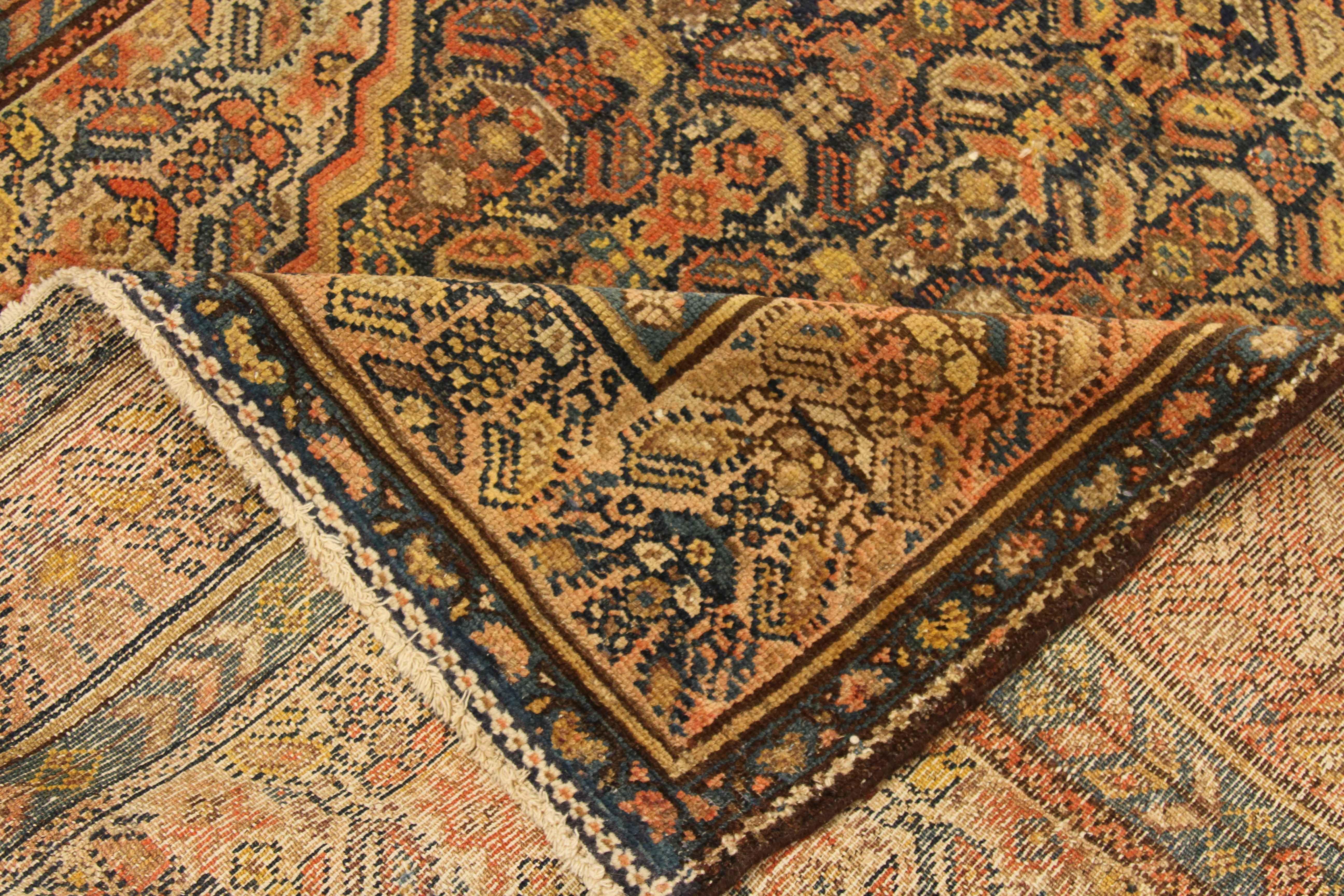 Antique Persian rug handwoven from the finest sheep’s wool and colored with all-natural vegetable dyes that are safe for humans and pets. It’s a traditional Malayer design featuring ‘Boteh’ details in red, yellow, navy and brown. It’s a beautiful