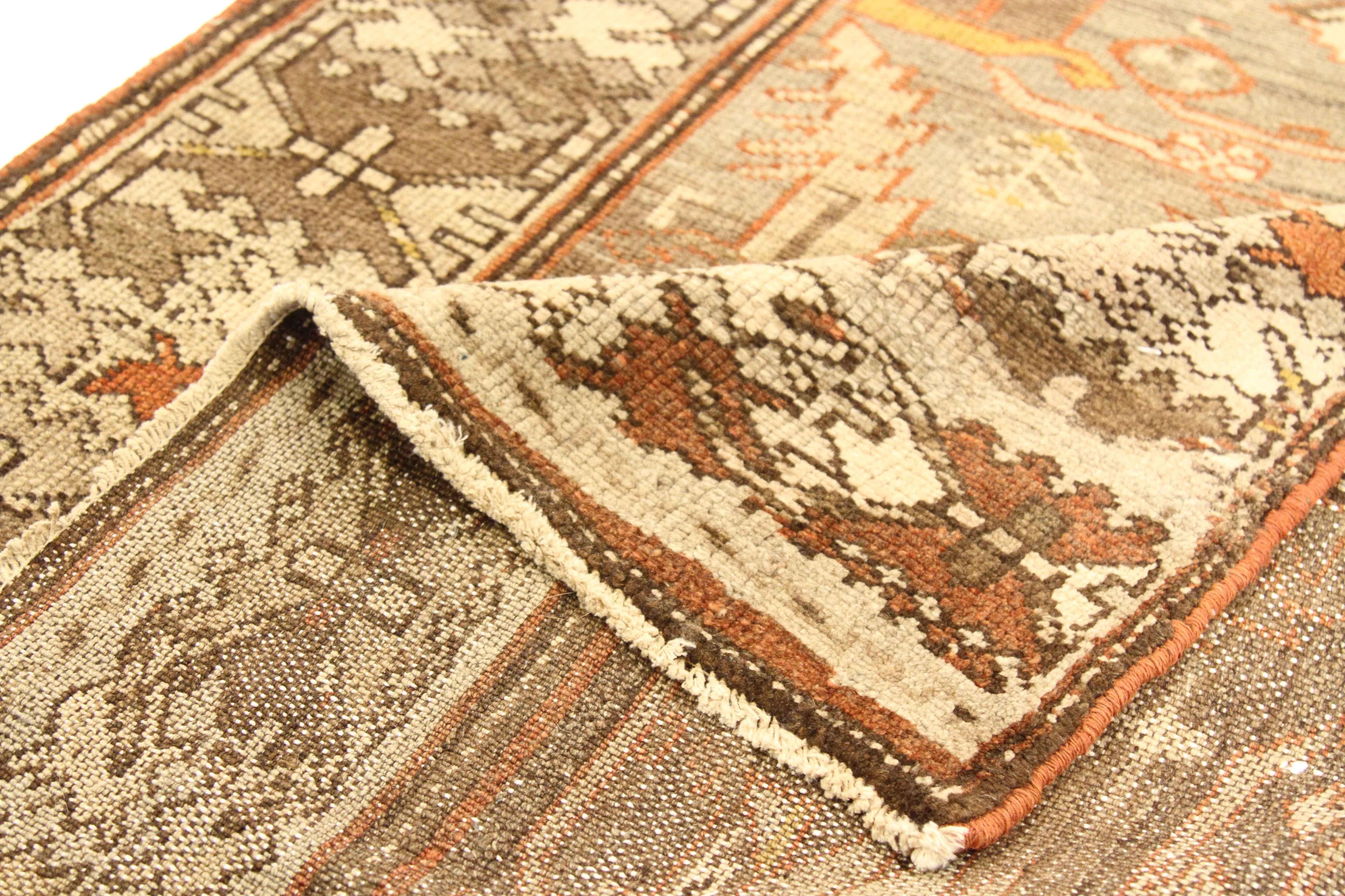 Crafted by hand using the finest wool and vegetable dyes, this antique Persian rug was woven in the 1950s using techniques and designs made famous by Zanjan weavers. It showcases exquisite tribal details cleverly infused with colors of brown, green,
