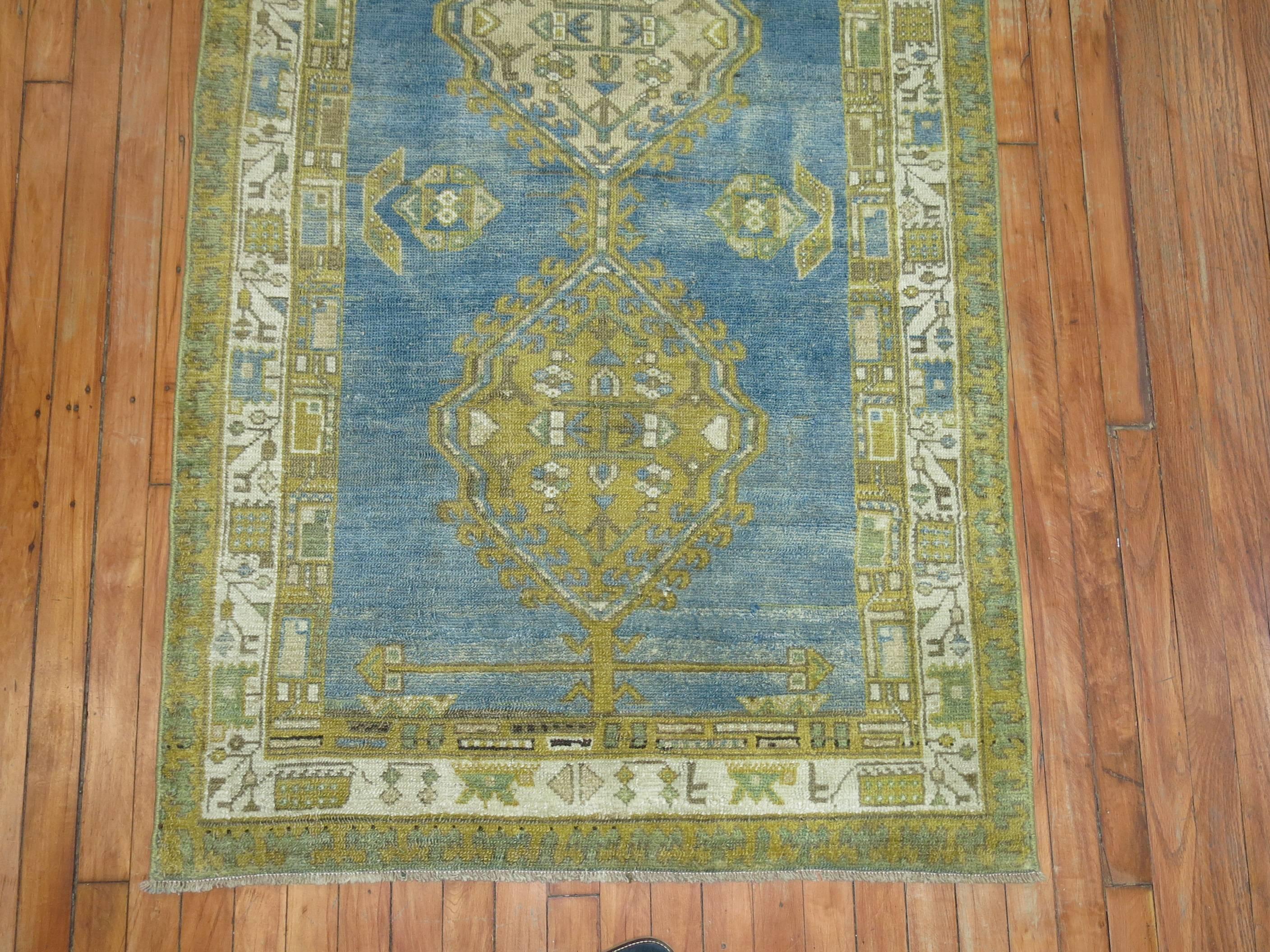 A Persian runner in pretty sky blues and green from the early part of the 20th century.
