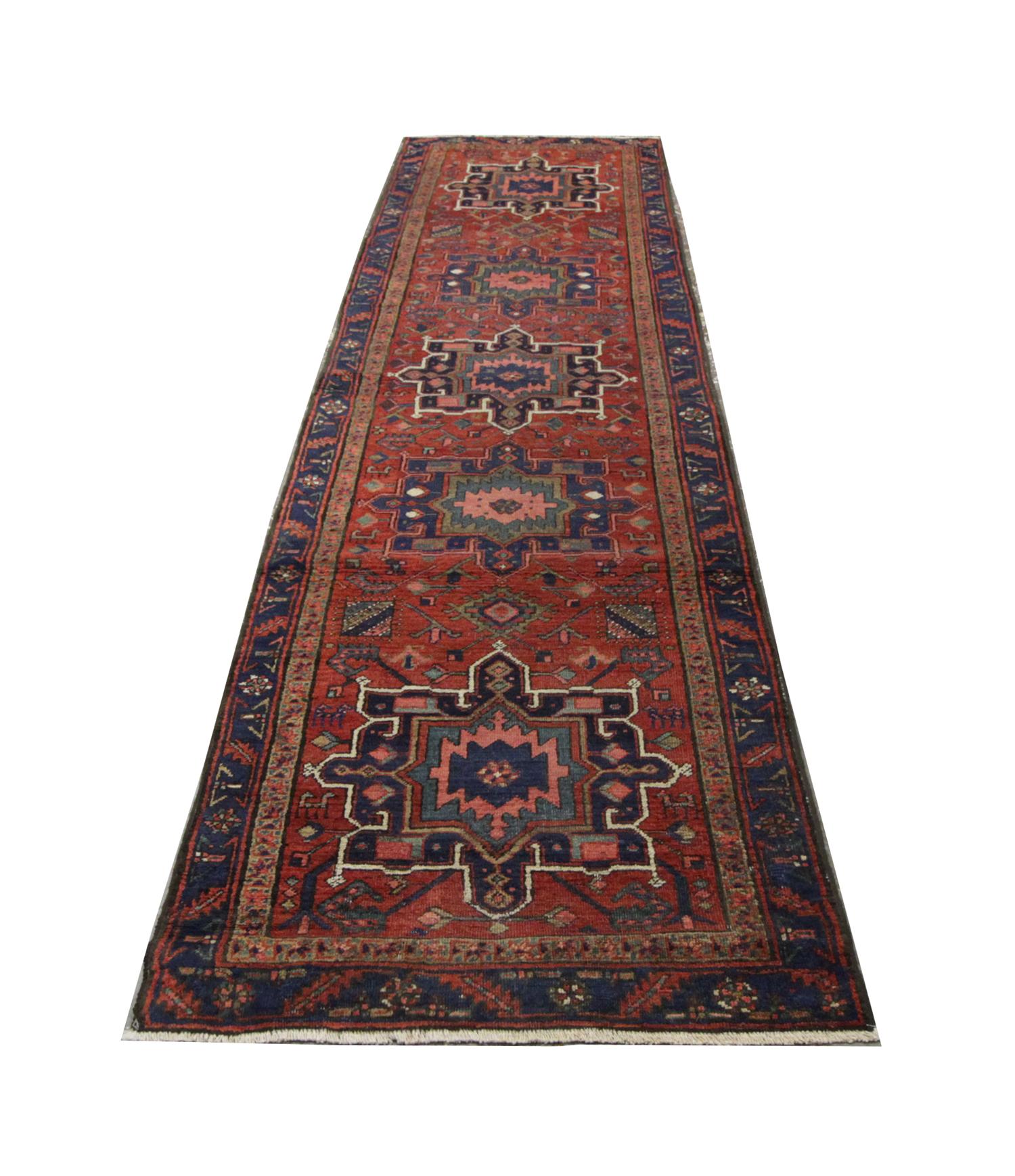 Tribal geometric designs run through the centre of this antique runner rug on a deep red background. A layered border encloses this. The handwoven rustic rug was constructed from handspun wool and cotton. (Antique Rustic Runner Rug 405x97)
