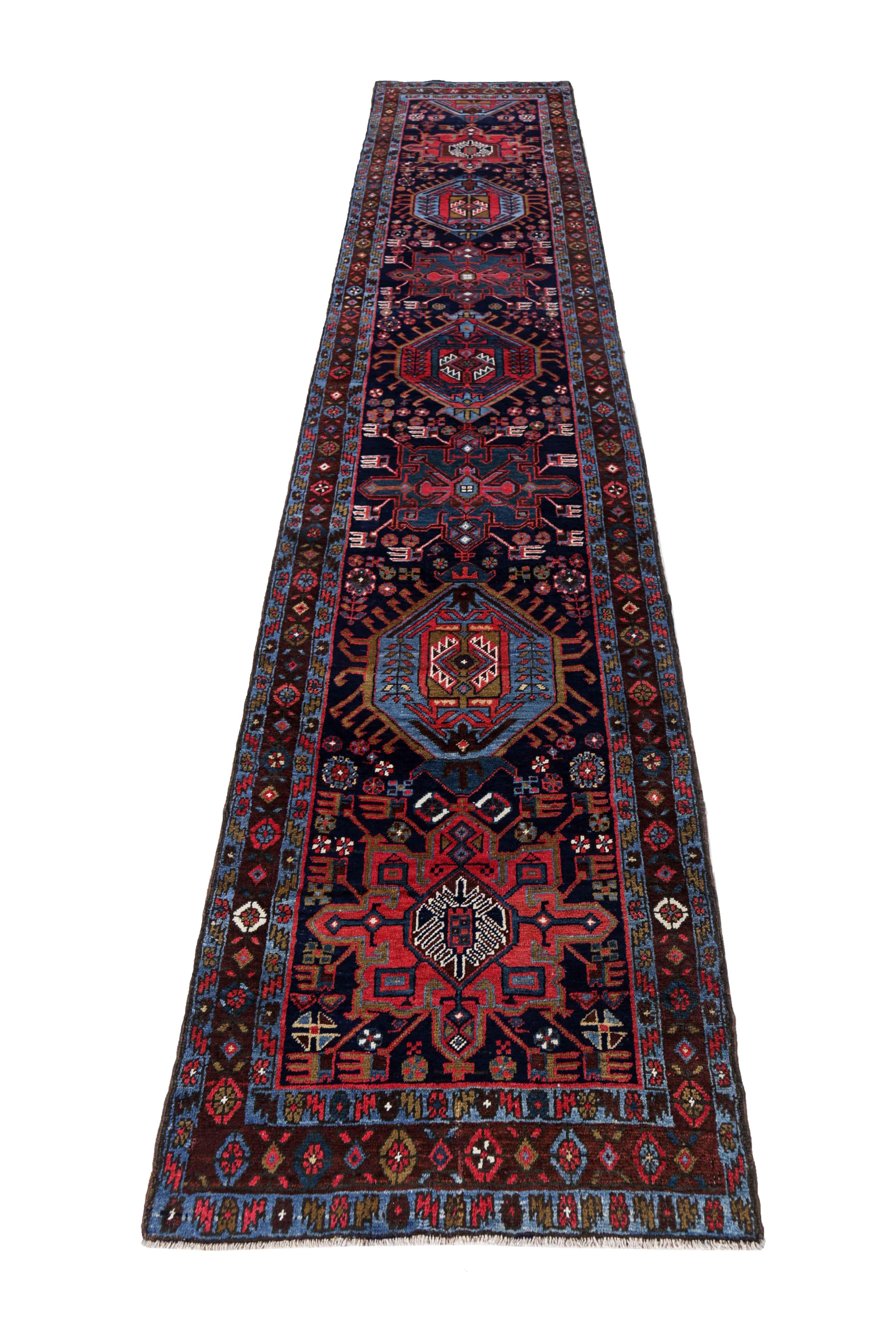 Antique Persian runner handwoven from the finest sheep’s wool. It’s colored with all-natural vegetable dyes that are safe for humans and pets. It’s a traditional Heriz design handwoven by expert artisans.It’s a lovely runner rug that can be
