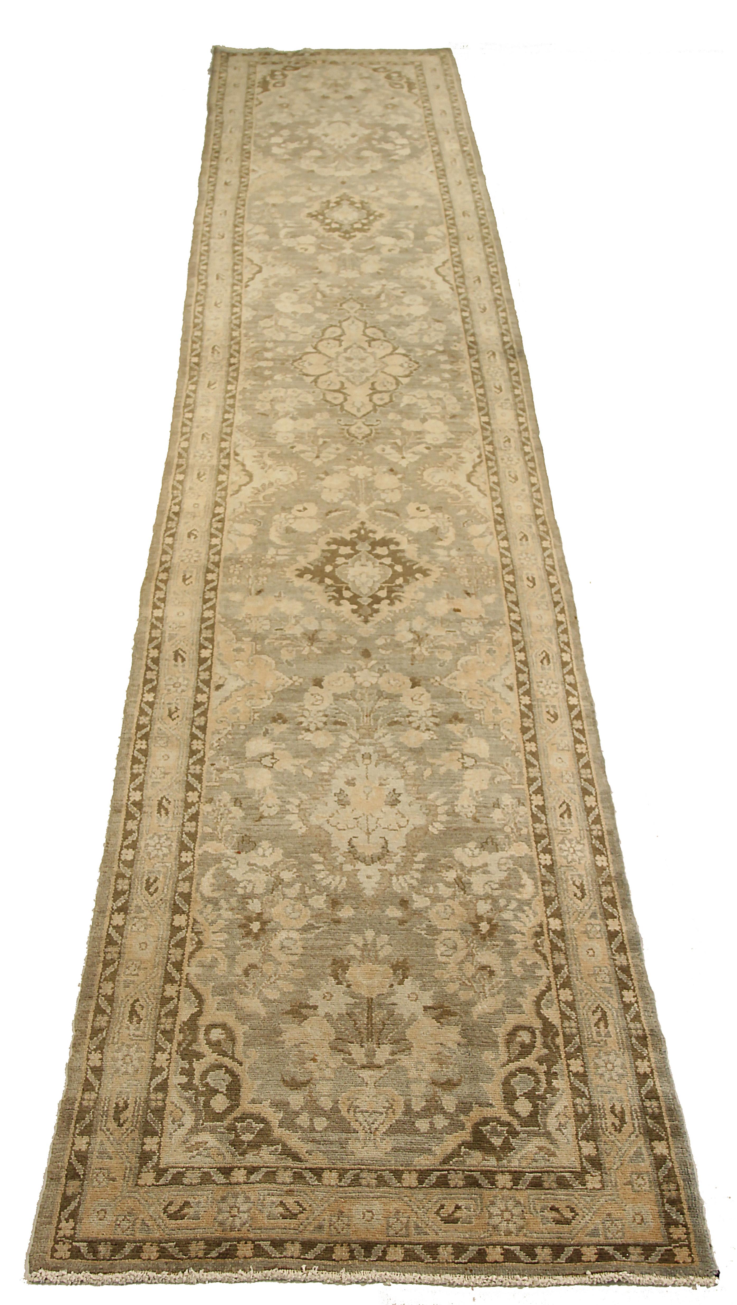 Antique Persian runner rug handwoven from the finest sheep’s wool. It’s colored with all-natural vegetable dyes that are safe for humans and pets. It’s a traditional Malayer design featuring floral and tribal design on a beige field. It’s a lovely