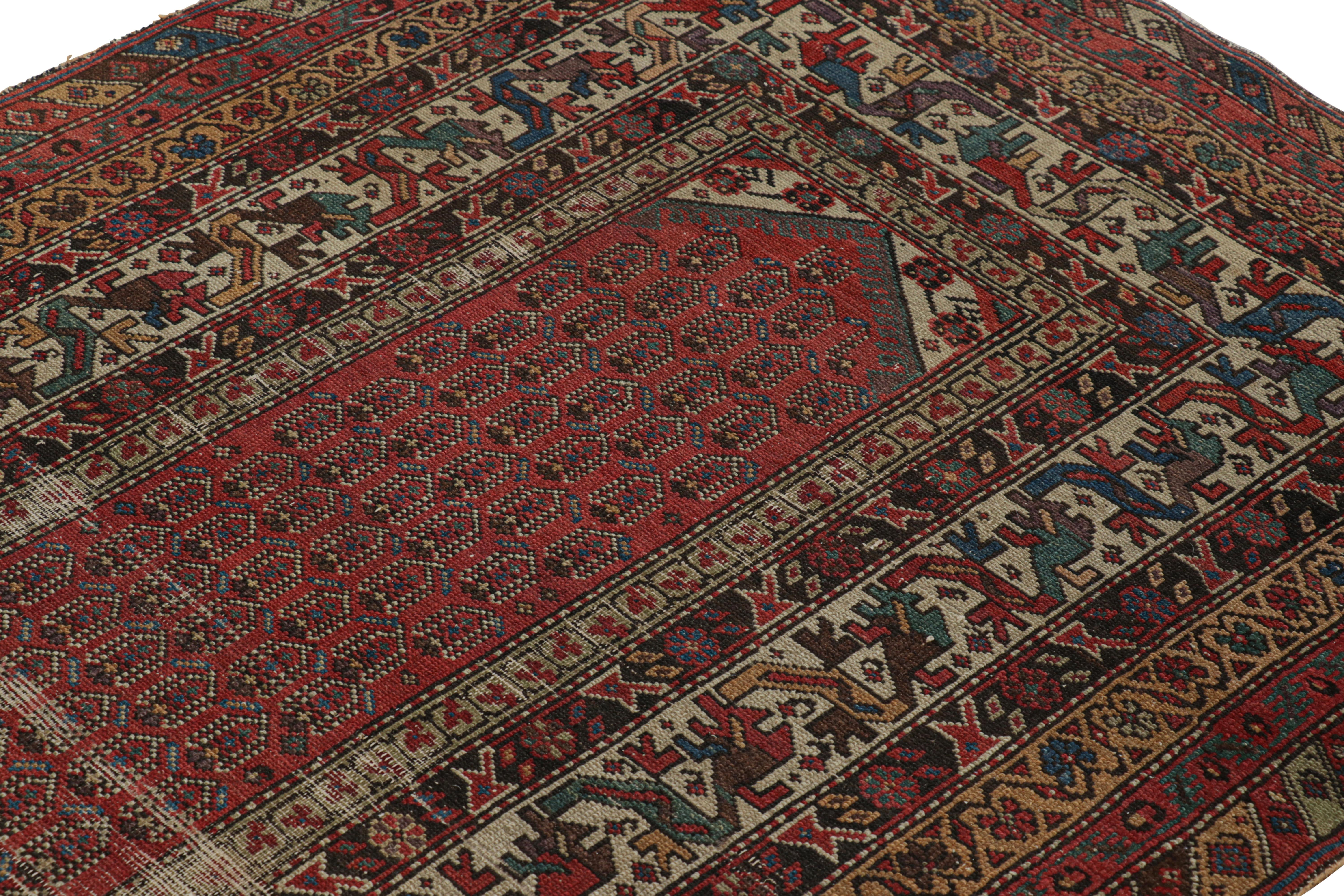 Hand-knotted in wool circa 1910-1920, this 4x8 antique Persian runner rug is a remarkable signature piece from Persia. It features colorful geometric patterns on a red field—a lovely design like few even in our collection of Persian pieces. 

On the