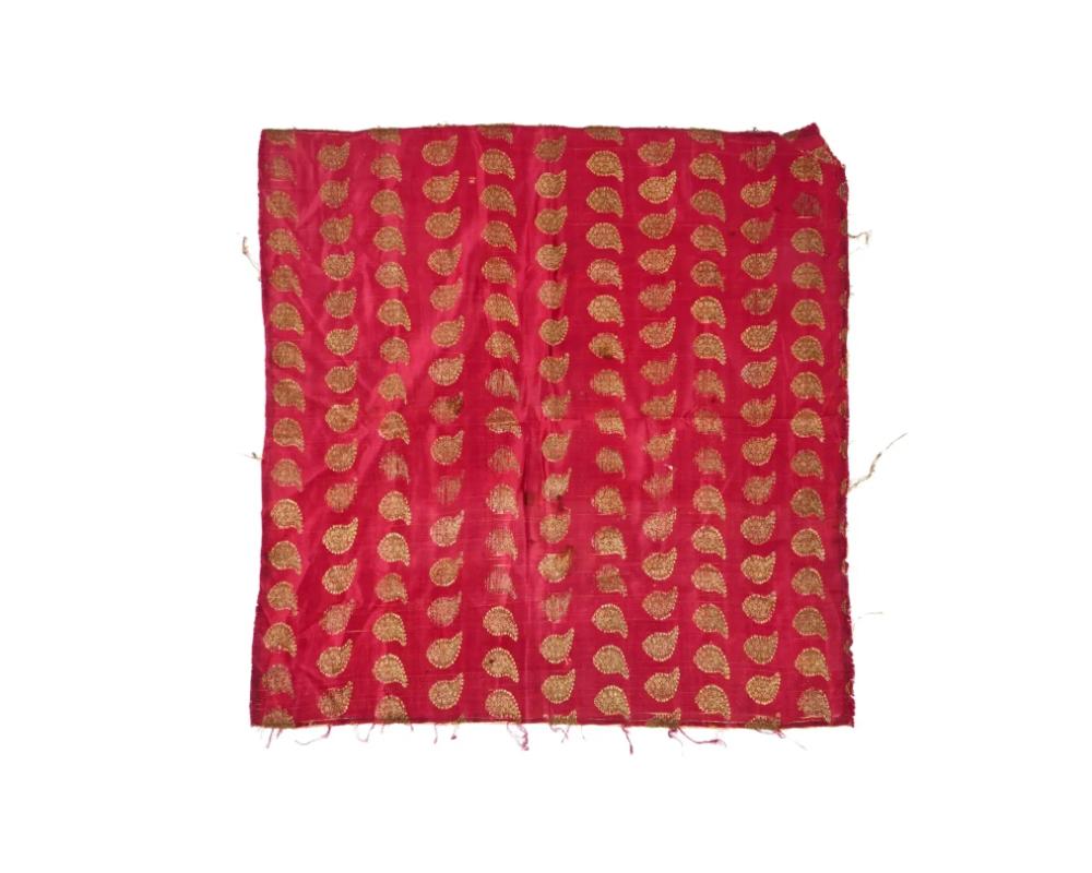 An antique Persian Iranian Safavid dynasty hand embroidered textile wall hanging. The textile is adorned with a traditional gold threaded paisley ornament on the red ground. Circa: 18th century. Safavid Iran or Safavid Persia, also referred to as
