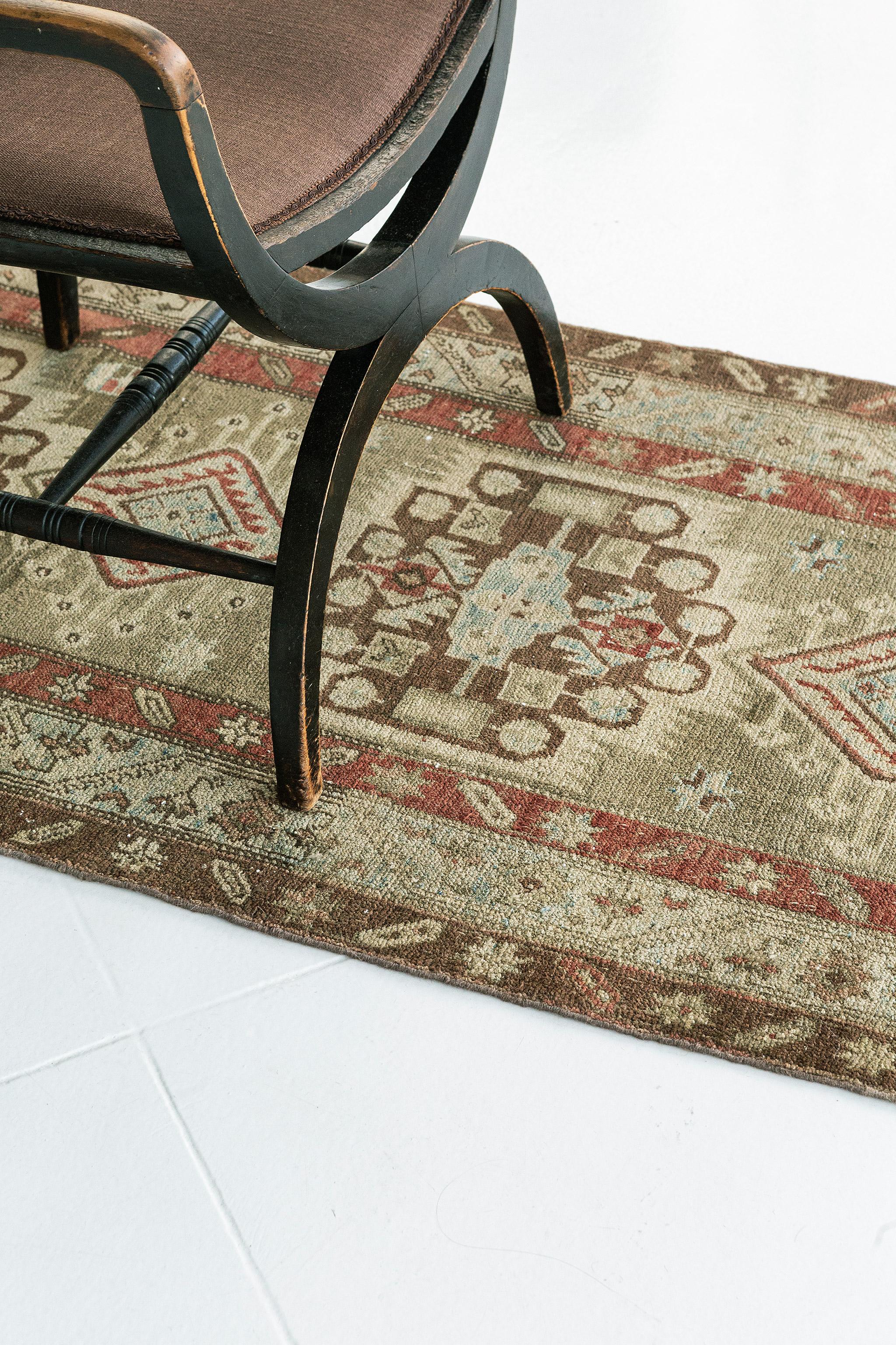This gorgeous Persian Sarab carpet features strong geometric lines and squares and a tribal pattern that would appeal to any traditionalist. Charming brown, blushing, and soft blue colors accentuate its beauty. This color scheme is perfect for a