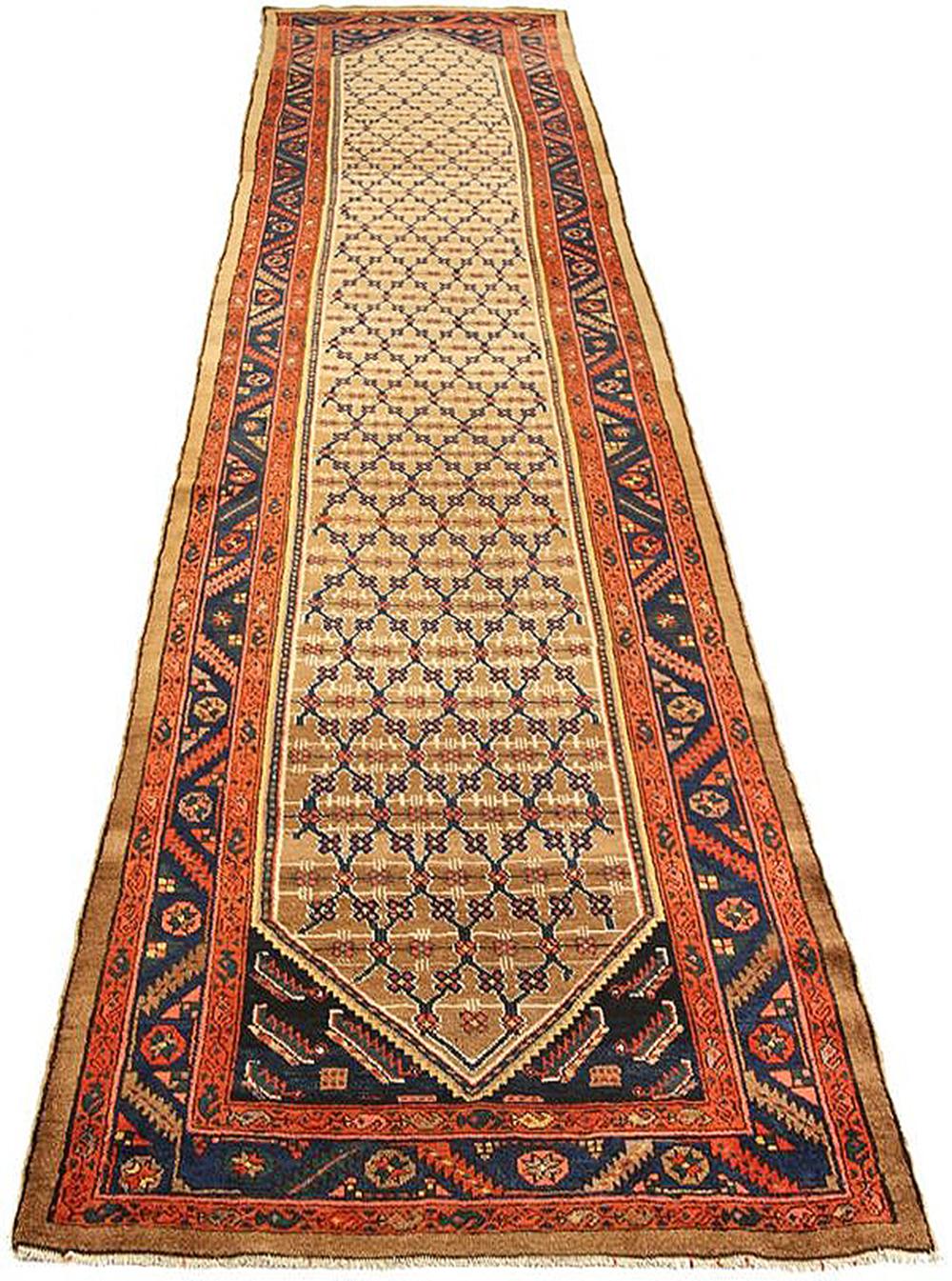 Antique Persian runner rug handwoven from the finest sheep’s wool and colored with all-natural vegetable dyes that are safe for humans and pets. It’s a traditional Sarab design featuring flower details in navy and brown over a beige center field. It