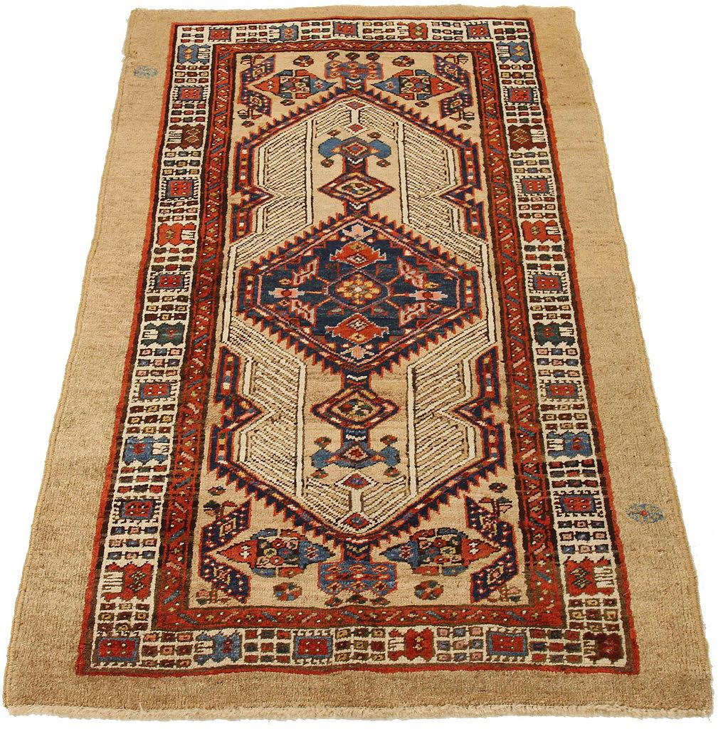 Antique Persian runner rug handwoven from the finest sheep’s wool and colored with all-natural vegetable dyes that are safe for humans and pets. It’s a traditional Sarab design featuring geometric details in navy, red, and white over a beige field.