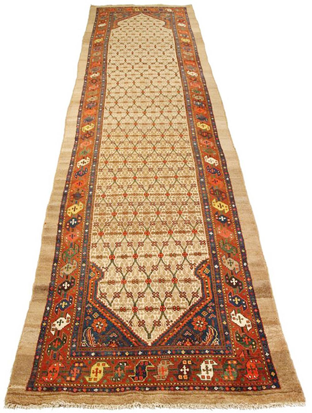 Antique Persian runner rug handwoven from the finest sheep’s wool and colored with all-natural vegetable dyes that are safe for humans and pets. It’s a traditional Sarab design featuring geometric details in red and brown over white and beige field.