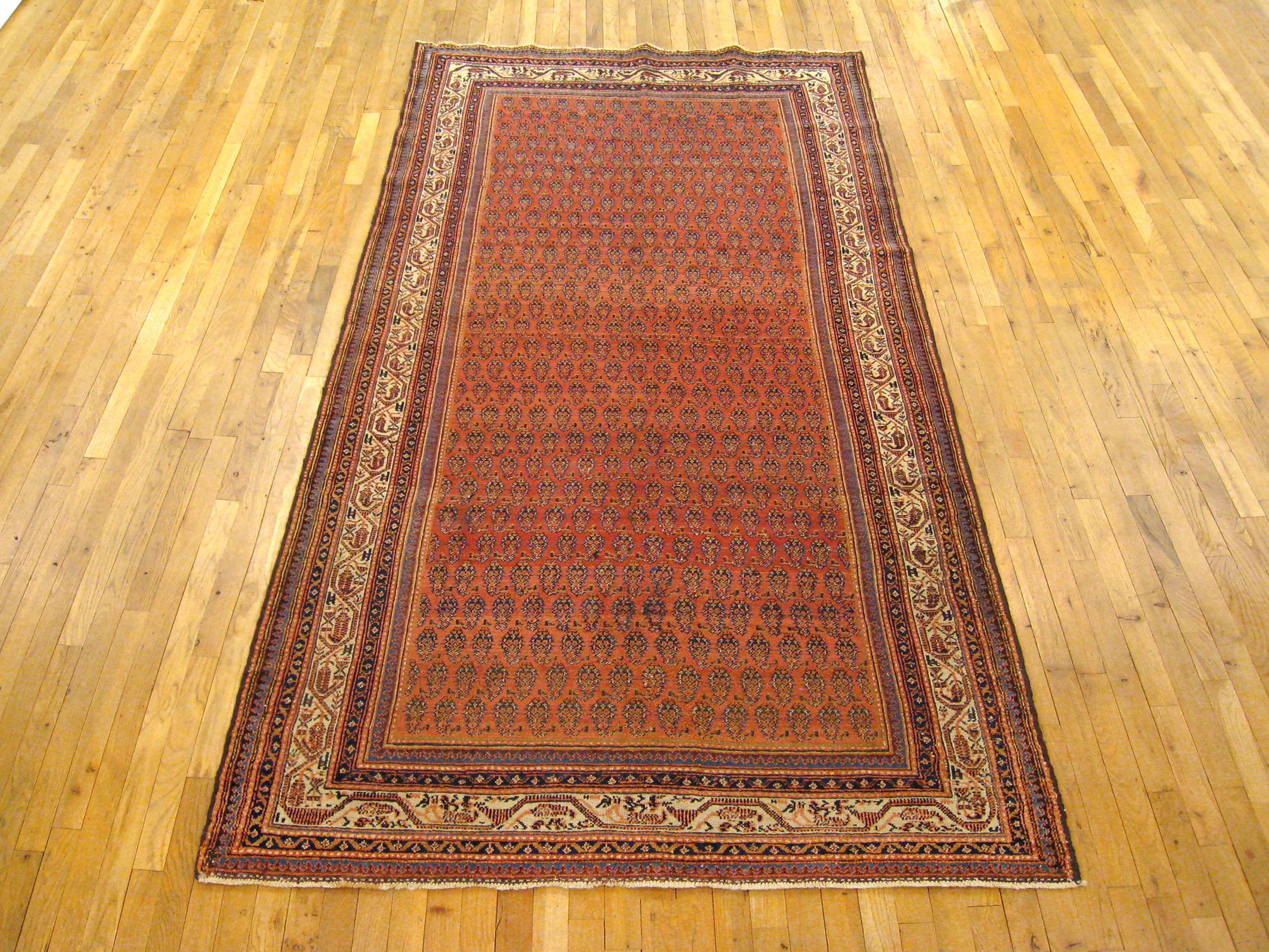 Antique Persian Saraband rug, Gallery size, circa 1910

A one-of-a-kind antique Persian Saraband Oriental Carpet, hand-knotted with thick and lustrous wool pile. This classic carpet features a Paisley design allover a large soft red field, with an