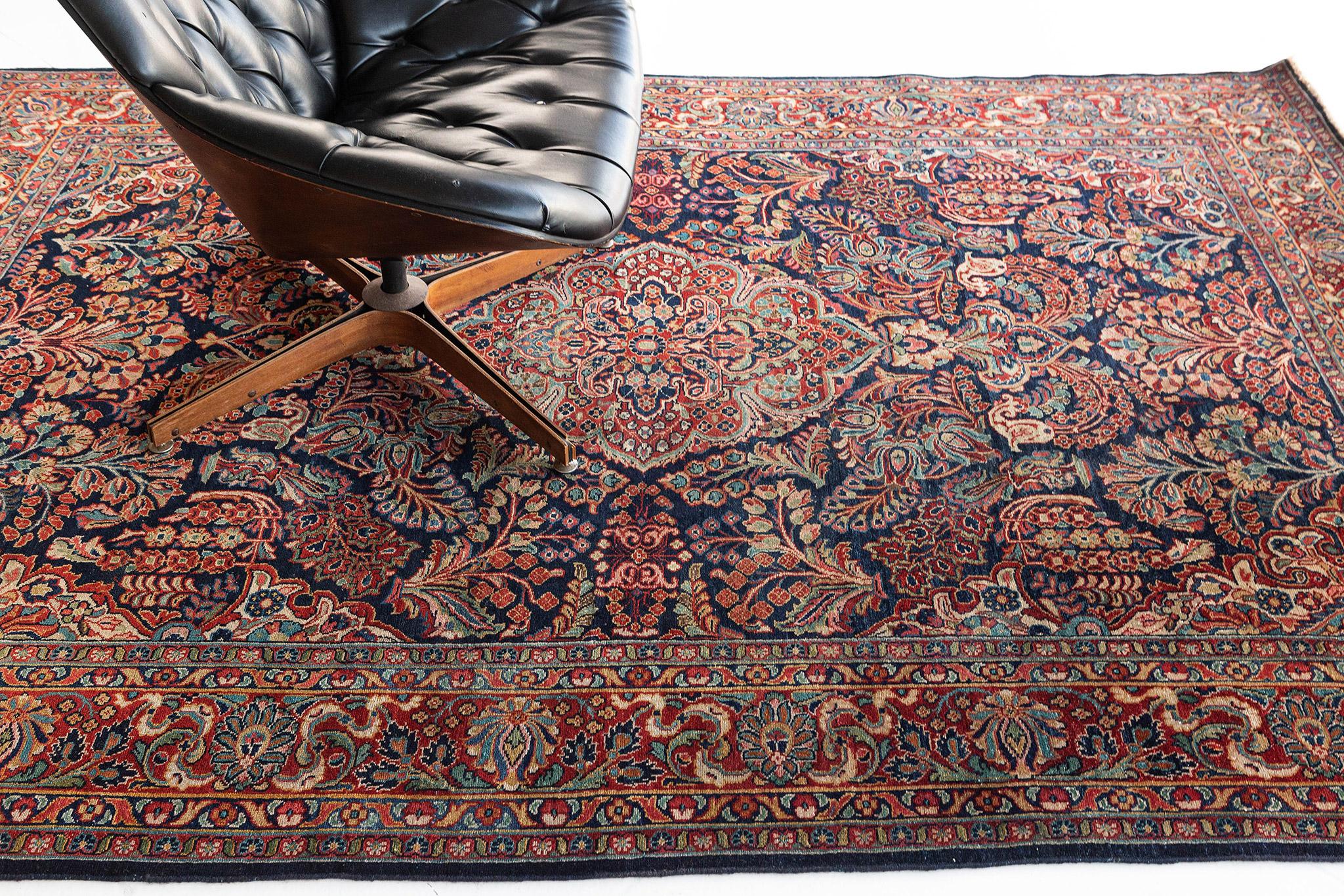 Characterized by an impressive and vibrant composition, this eccentric Sarouk Persian Rug showcases some of the finer points of classical Persian rug weaving. A dazzling earth-toned palette enhances an alluring design to form a gorgeous