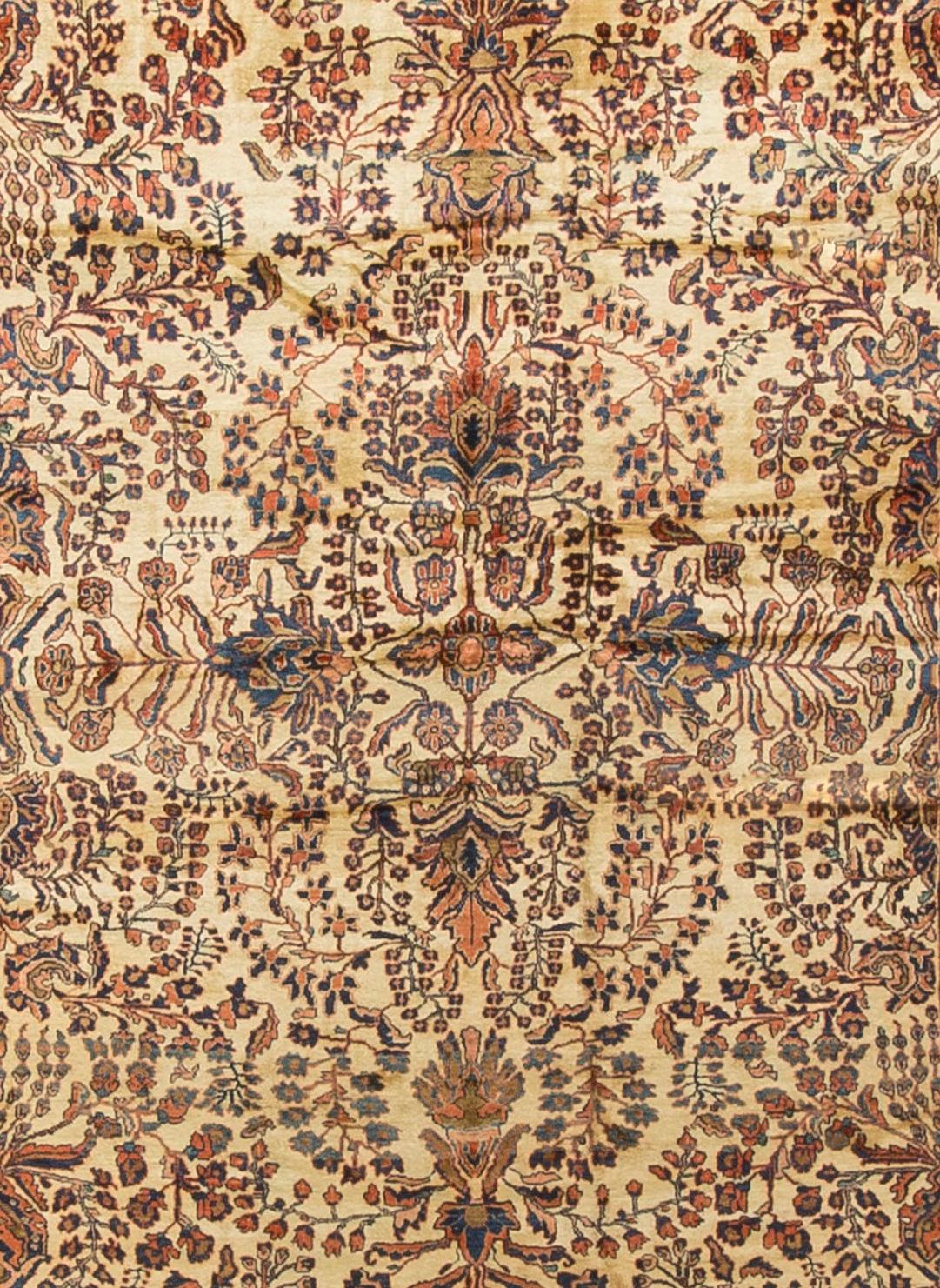 Antique Persian Sarouk Rug Circa 1900. The distinctive colors of this Sarouk rug reflects the style that became so popular in the USA at the beginning of the 20th century. The soft rust-red ground so well complimented by the floral patterns in blues