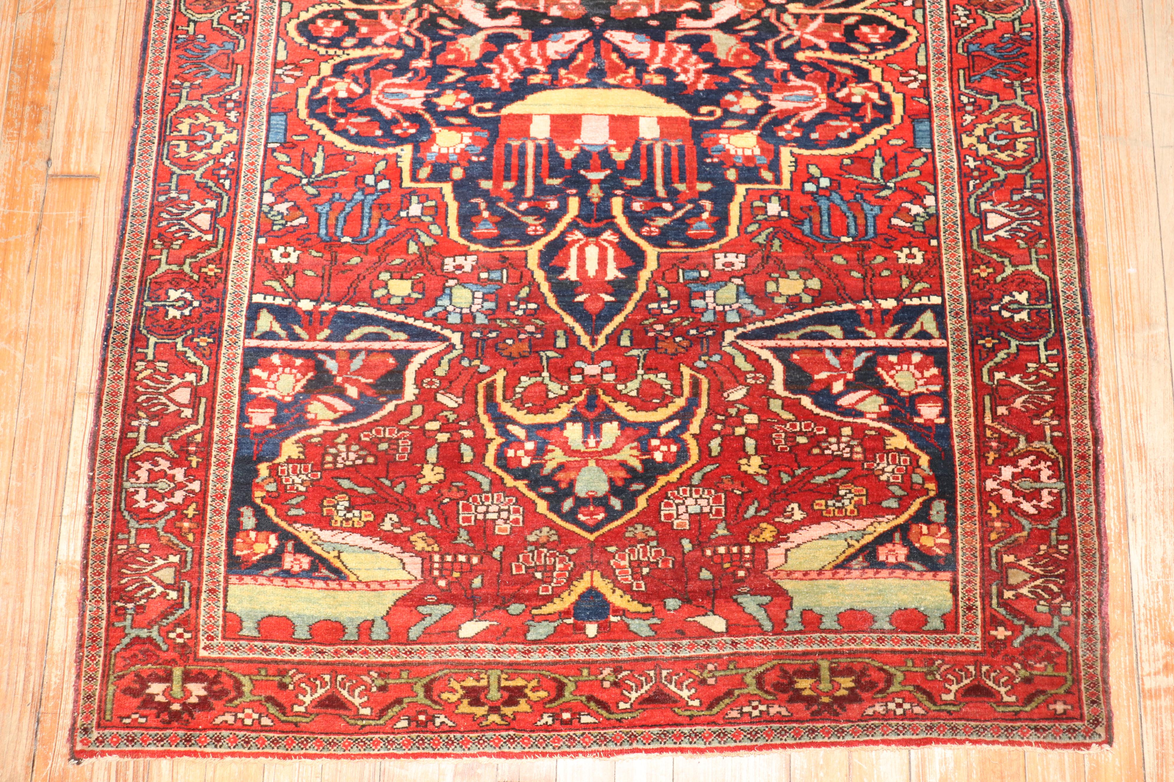 Super quality early 20th century Persian Sarouk Ferehan carpet. Deep red field and border with a navy blue medallion and accents in blue and green. 

Measures: ''3'5'' x 4'10''.